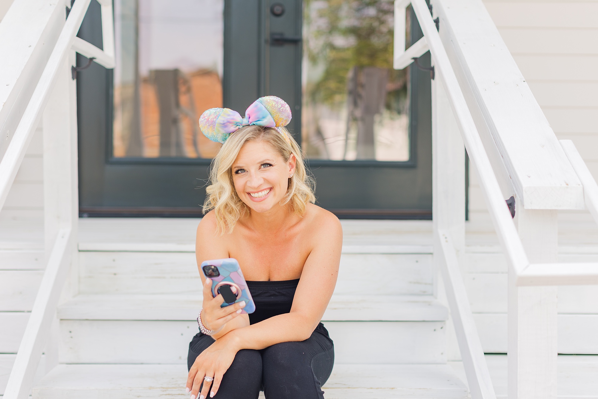 Disney trip planner sits on steps at OfNote during branding photos