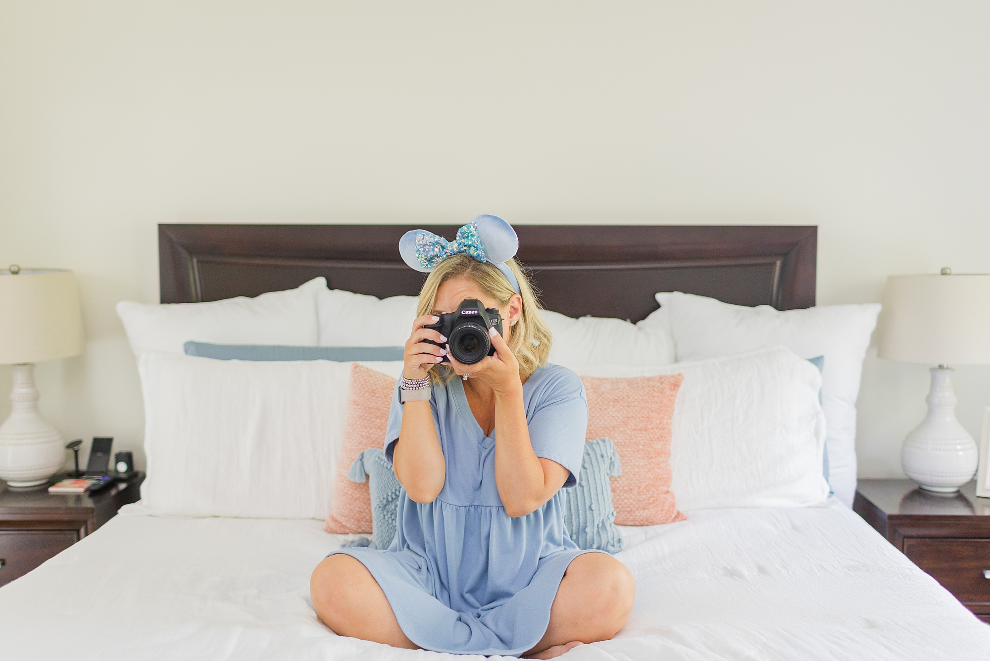 Franklin TN branding photographer sits on bed taking photo