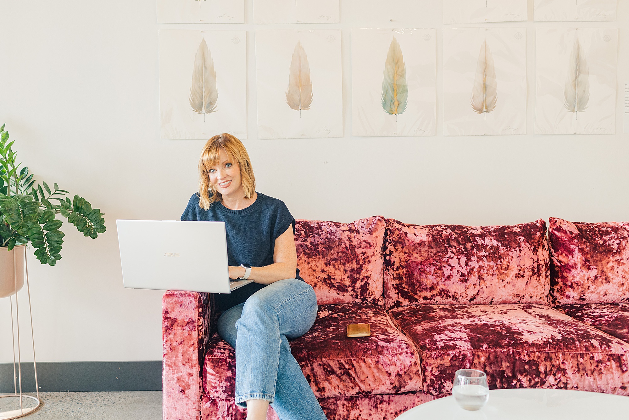 website designer sits on pink chair at Collective 615