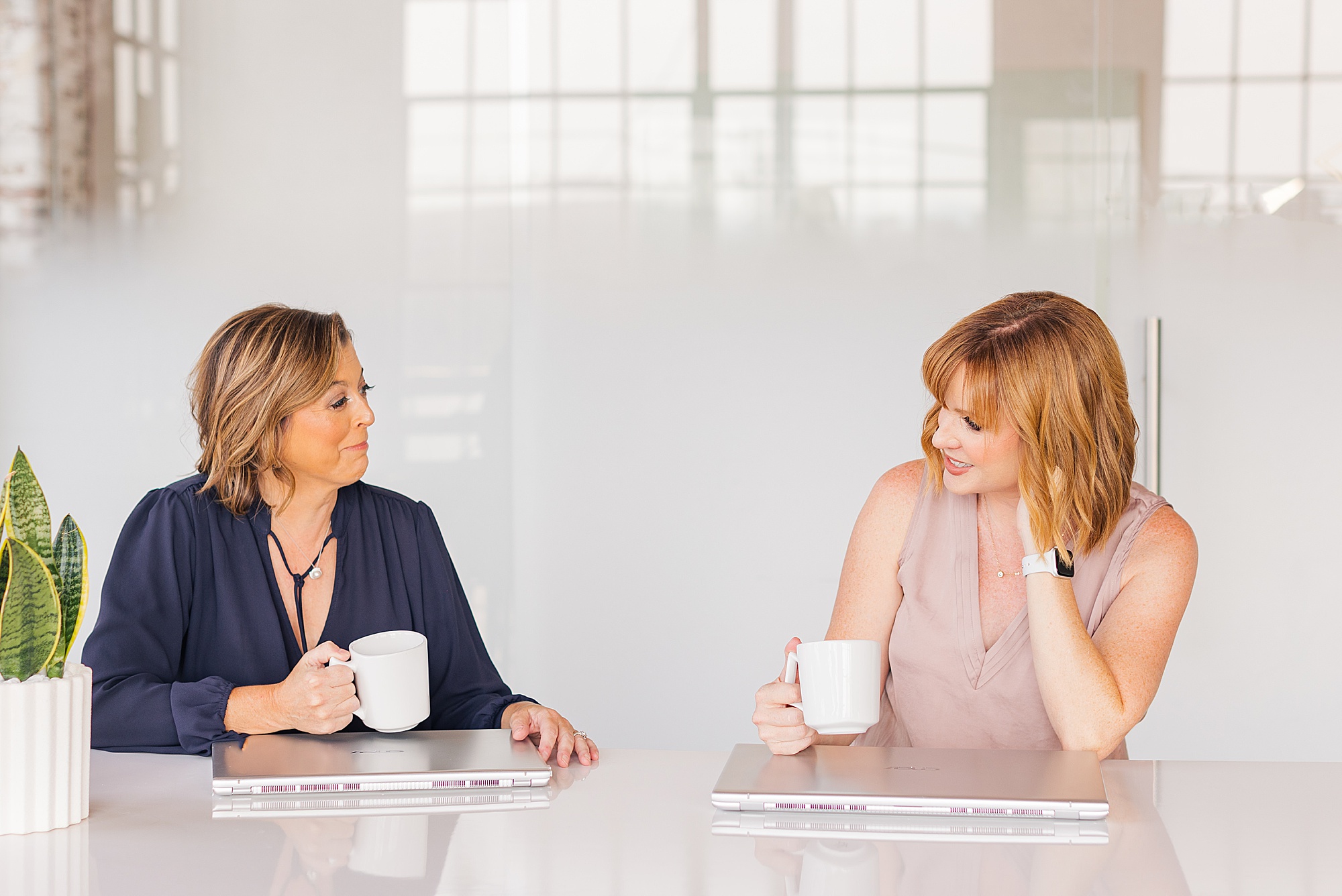 two women chat with white mugs during Collective 615 branding session