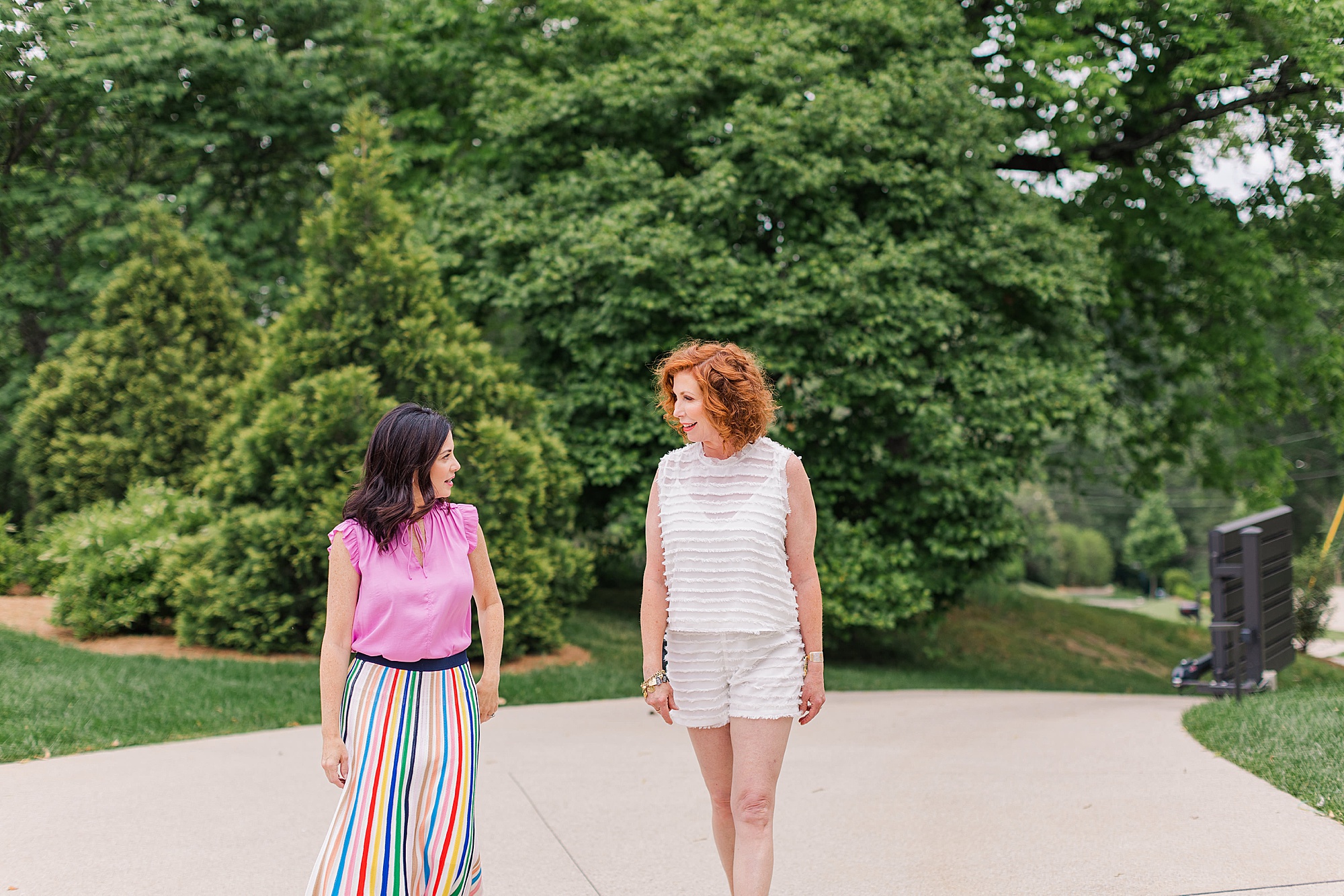 women walk down sidewalk during branding session in Nashville TN