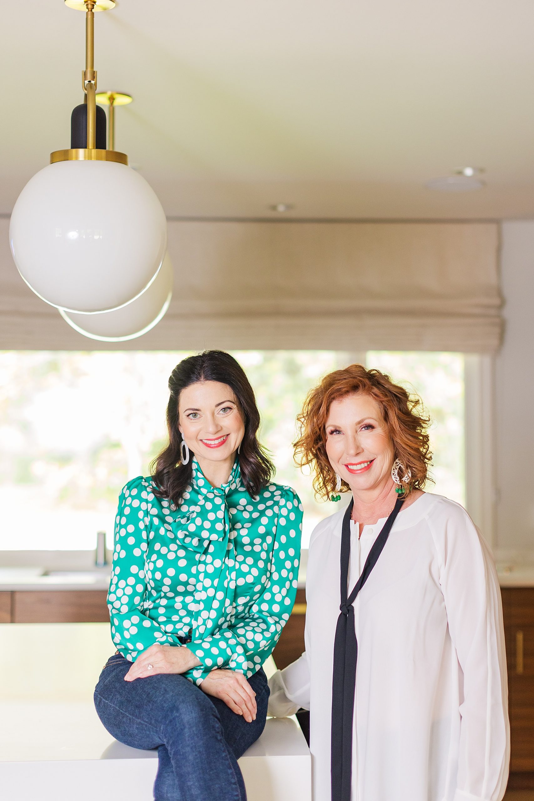 two women pose in kitchen during branding photos
