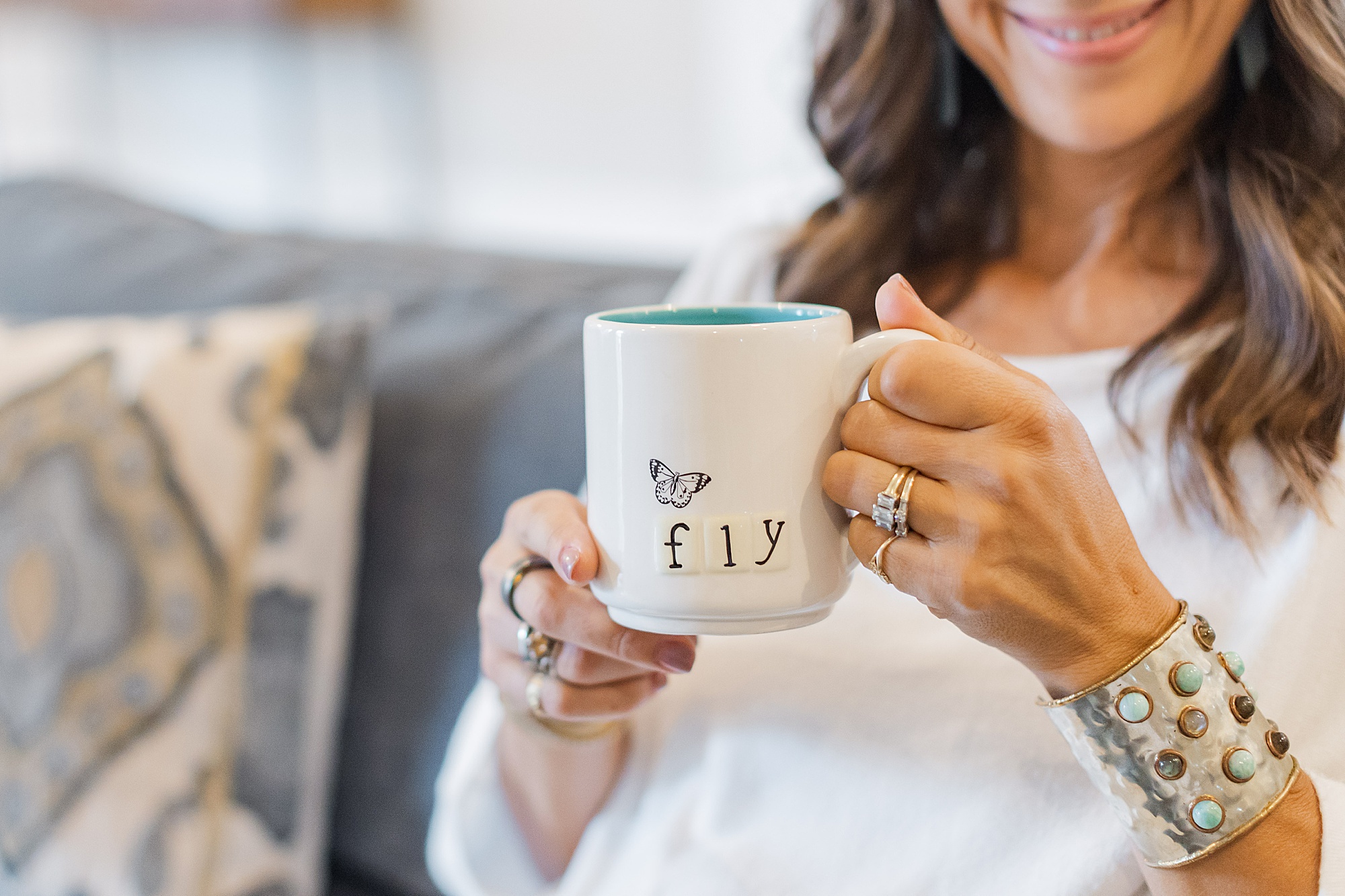 woman holds coffee mug on couch during Franklin branding photos