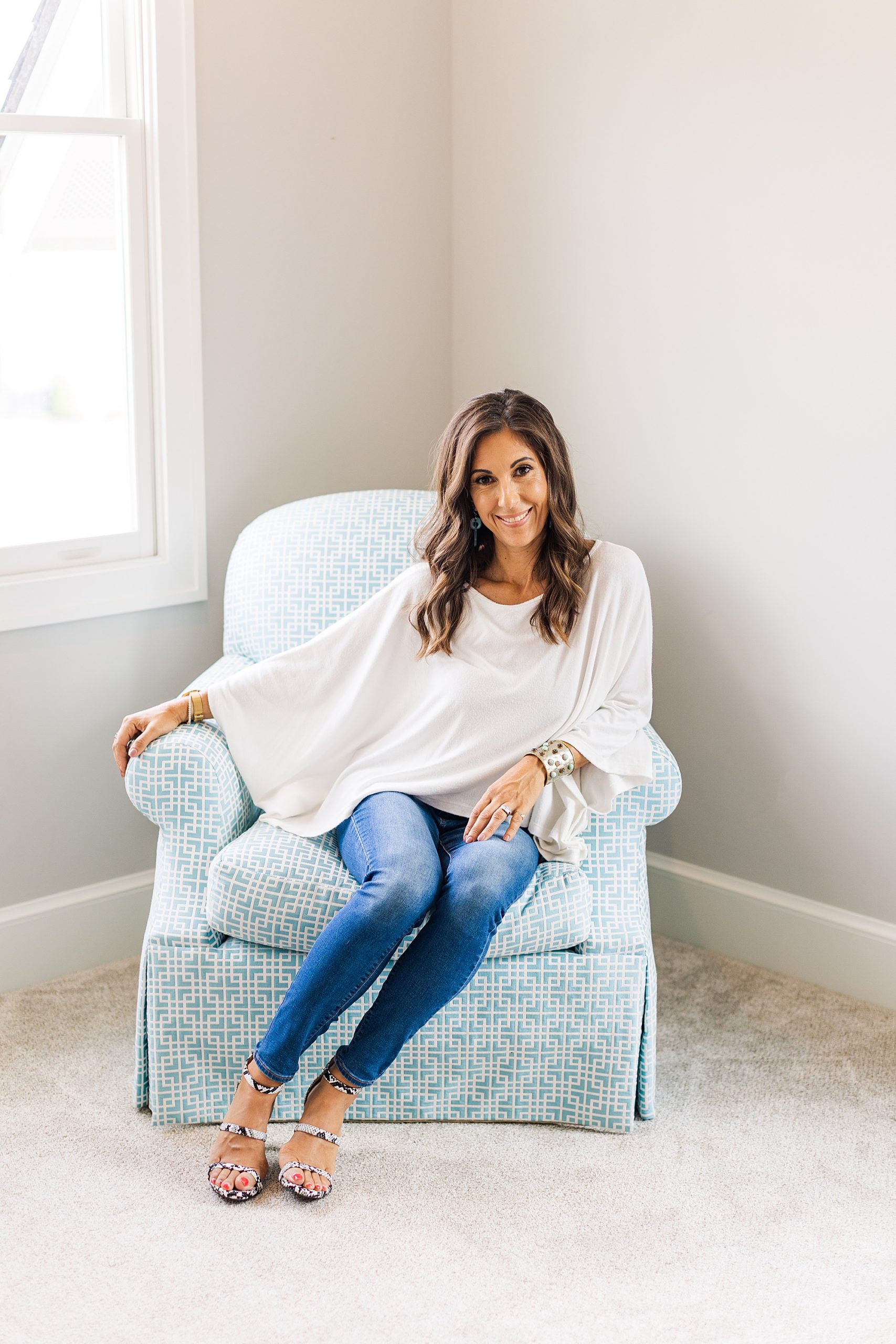 health coach sits in blue chair during Franklin branding photos