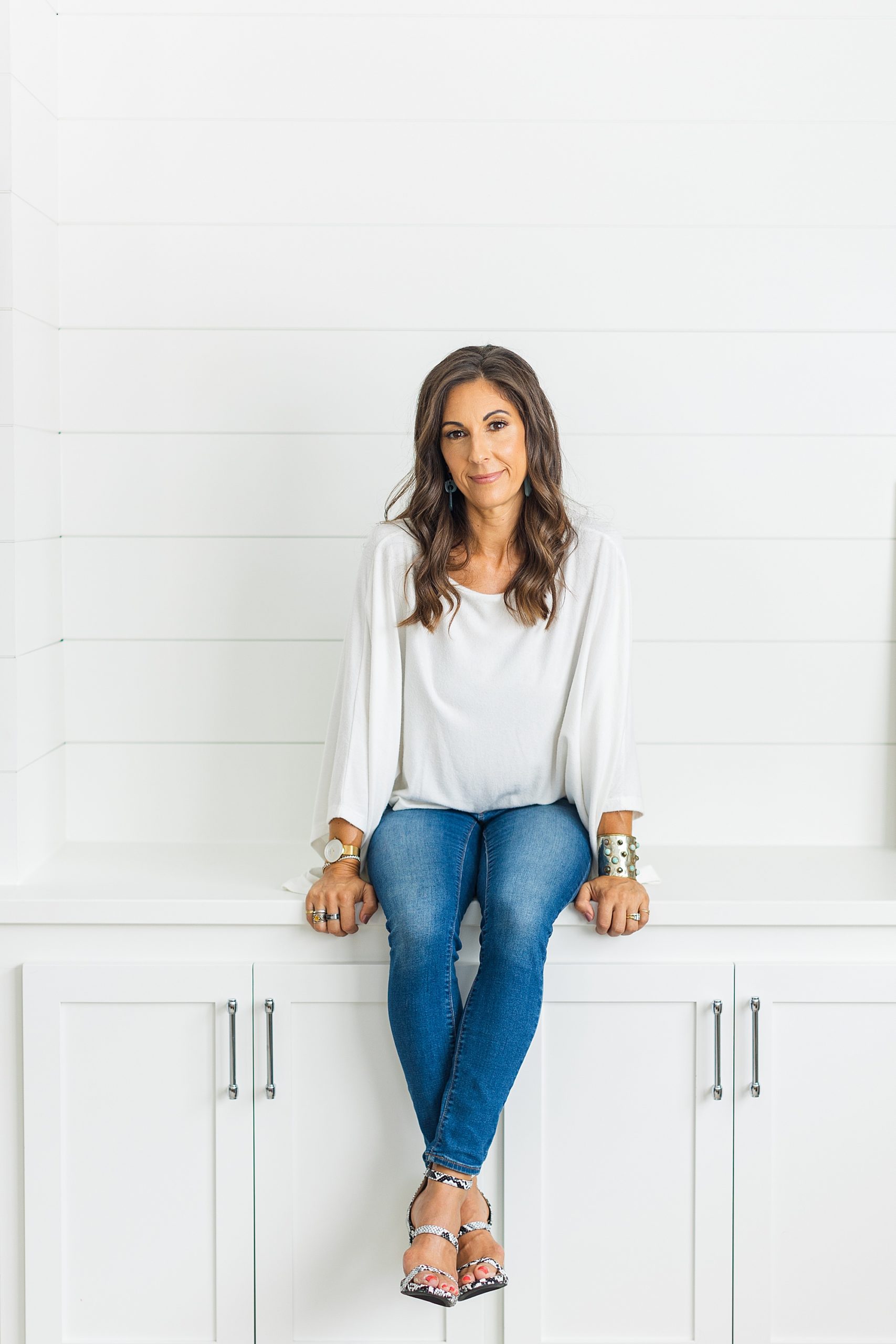 health coach sits on white table during branding photos