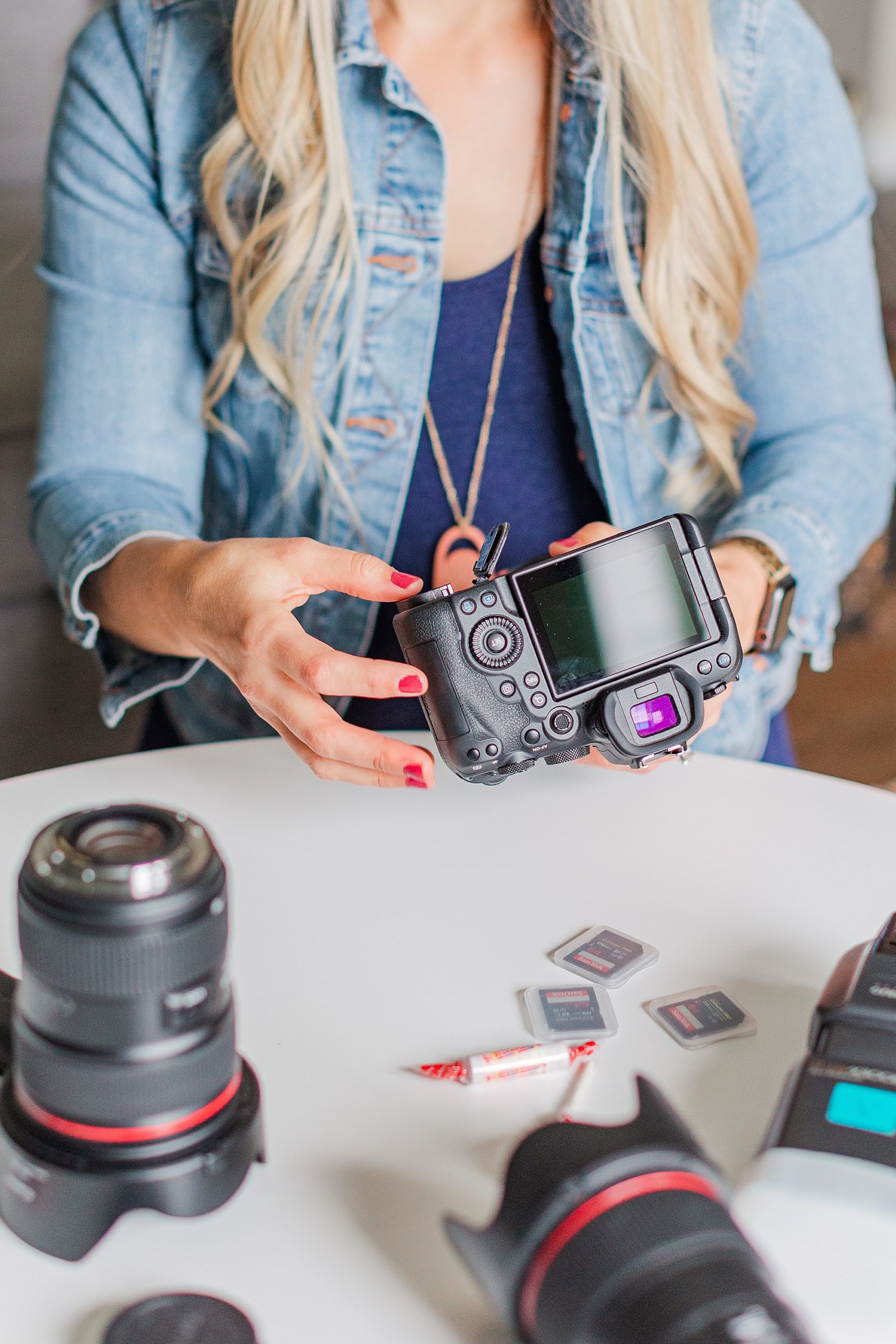 photographer adjusts battery in camera during branding photos
