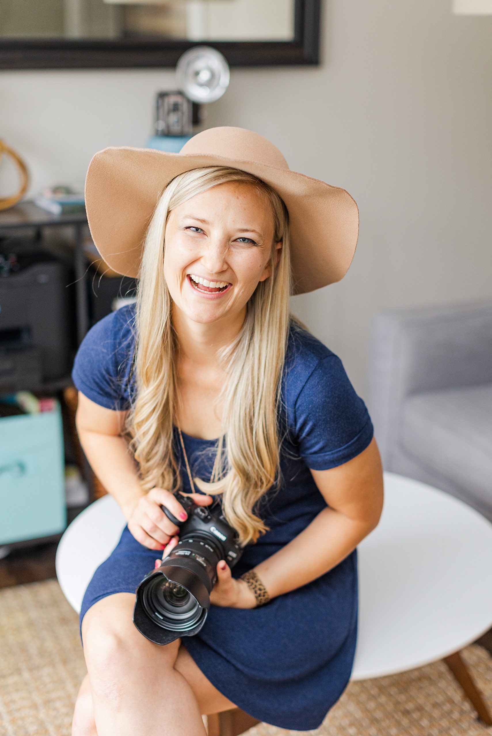 woman laughs holding camera at home