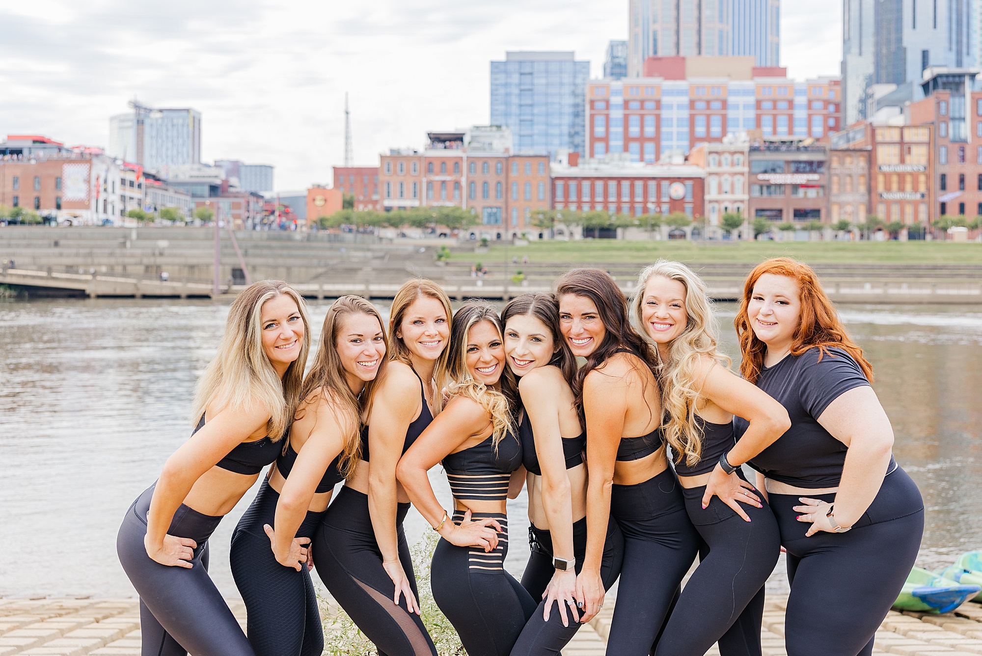 coaches in black outfits pose together during fitness coach branding session in Nashville TN