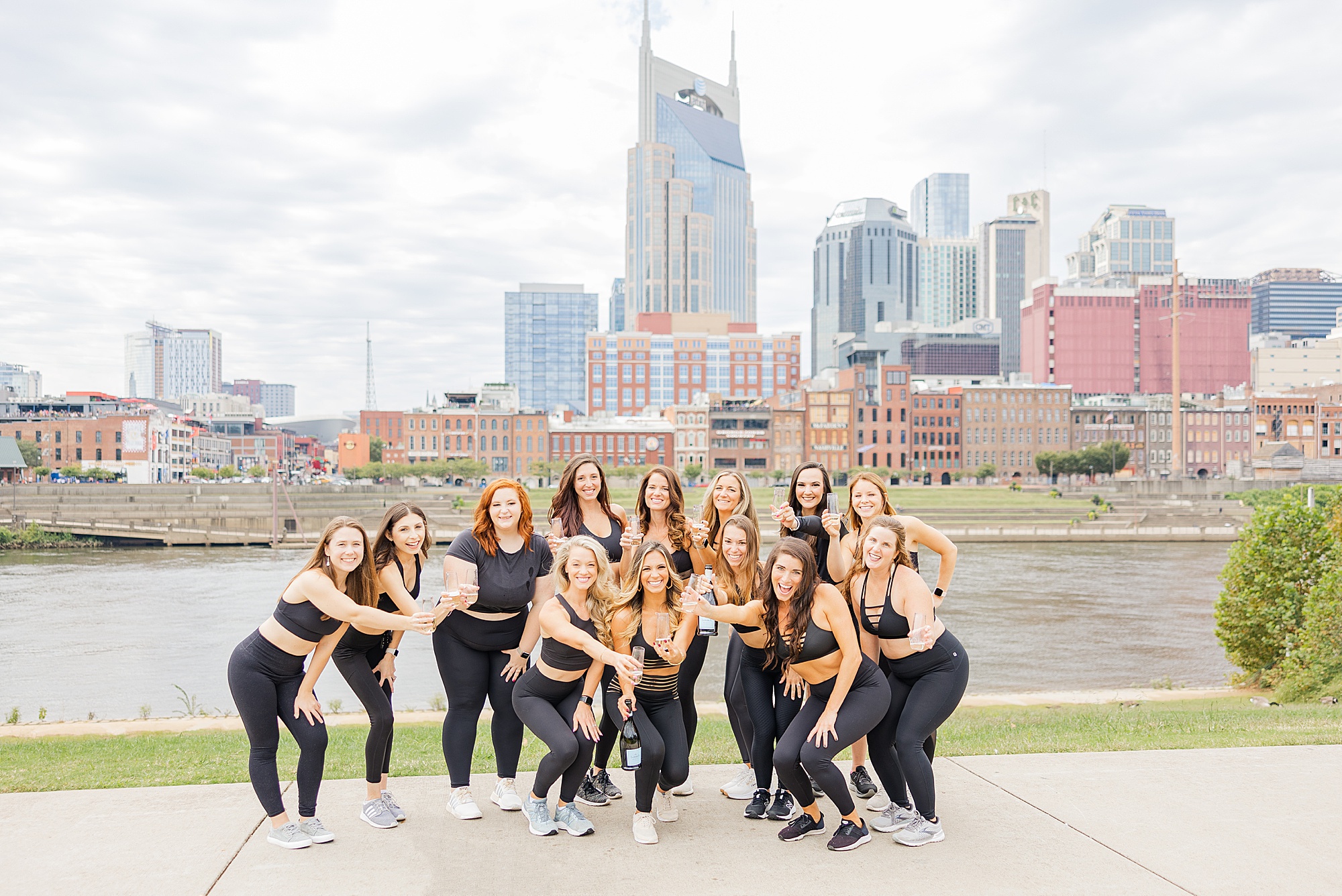 group of coaches poses together against Nashville skyline