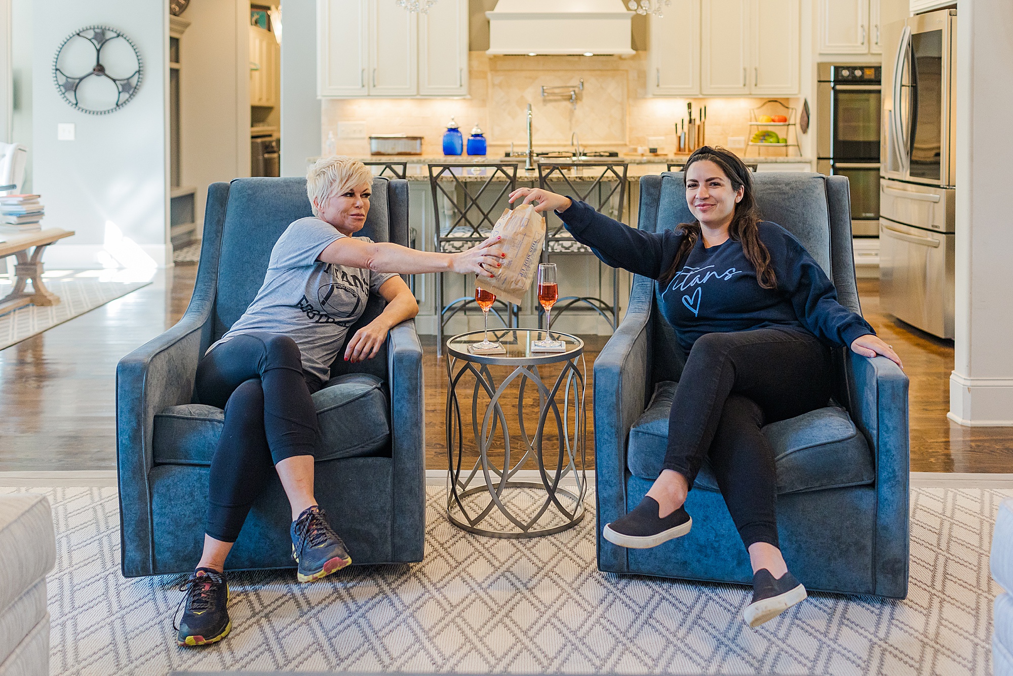 women sit on couch eating popcorn during Nashville real estate branding portraits