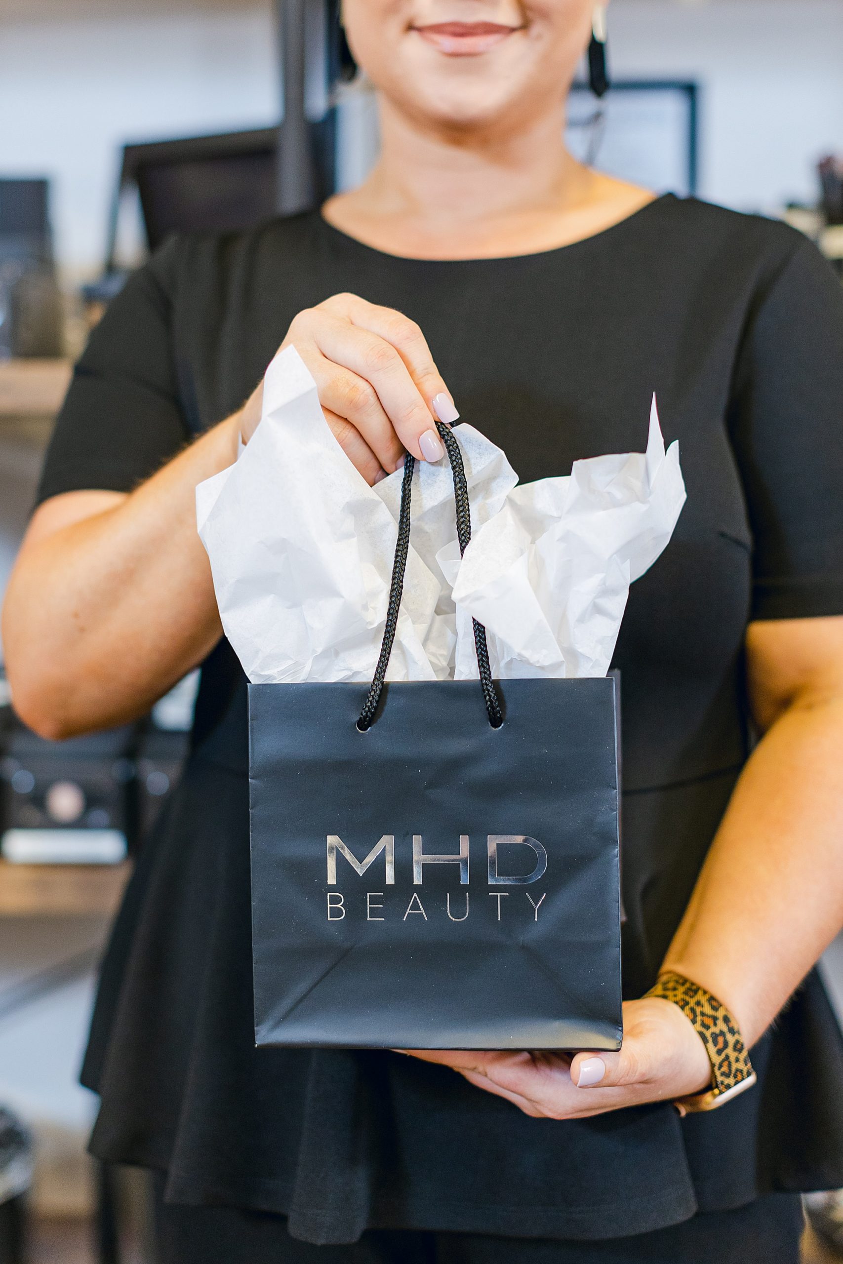 woman holds bag with branding on in it Nashville salon