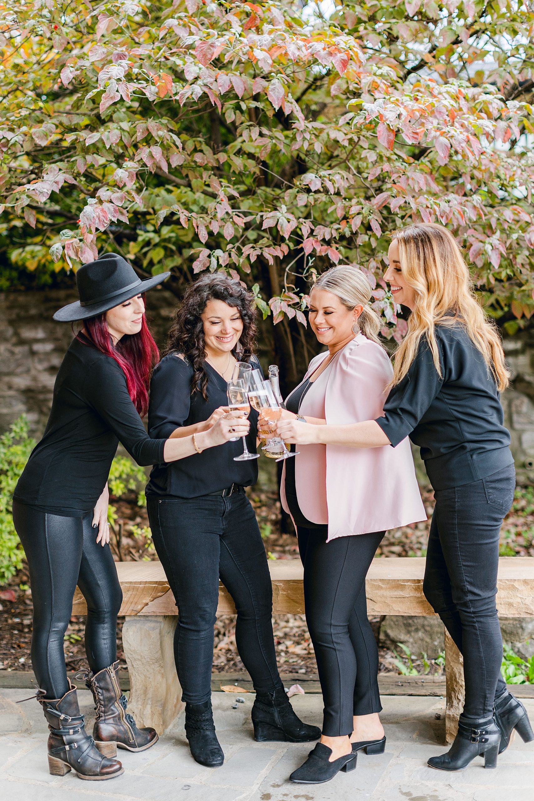 woman and team toast champagne during branding photos