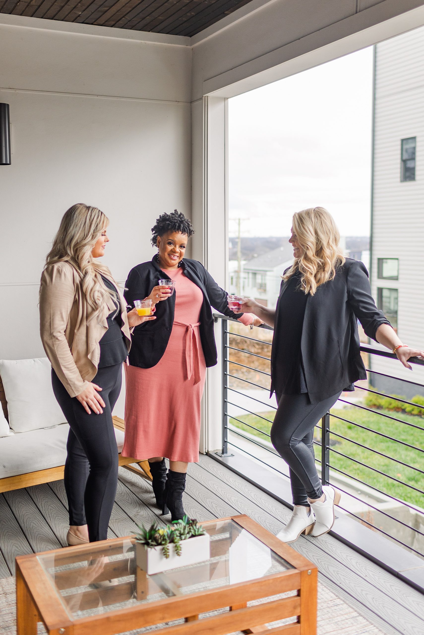 women chat on balcony during retreat in East Nashville
