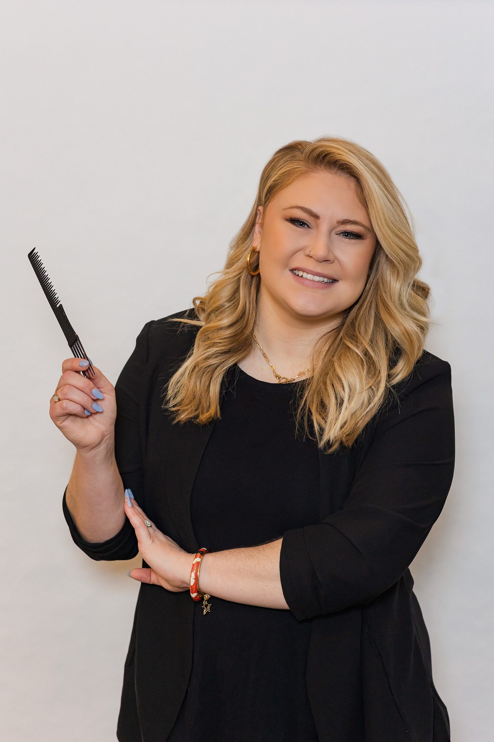makeup artist holds product during headshot