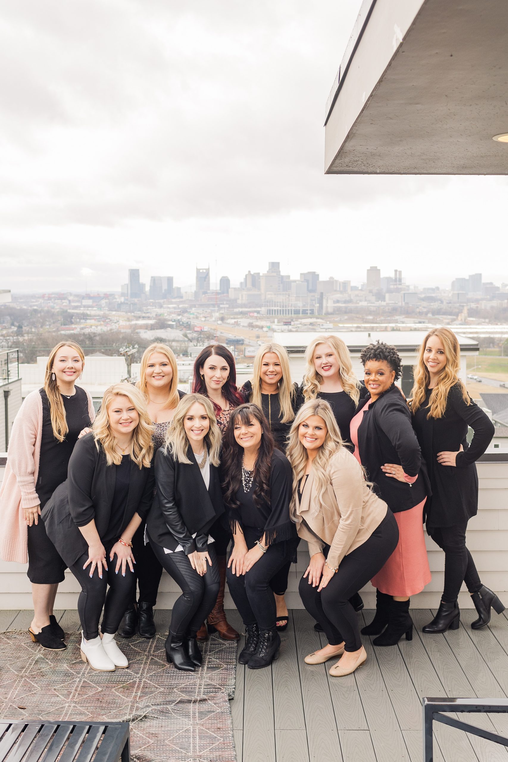 makeup team stands on balcony at airbnb in East Nashville