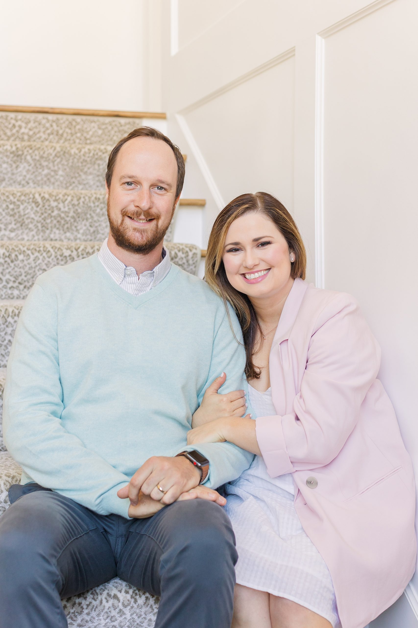 woman and husband sit on steps during branding session in Brentwood TN
