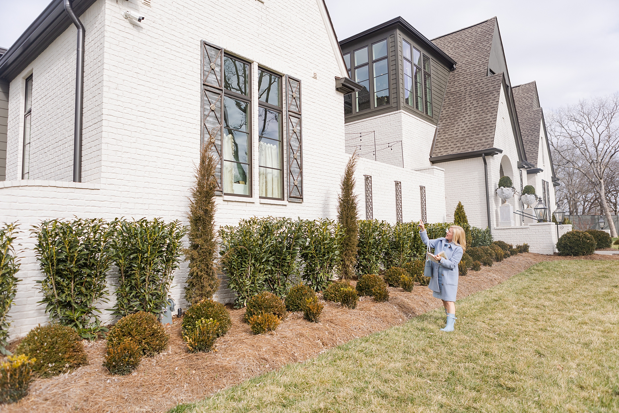 woman looks at landscaping at home during Bellevue TN branding session