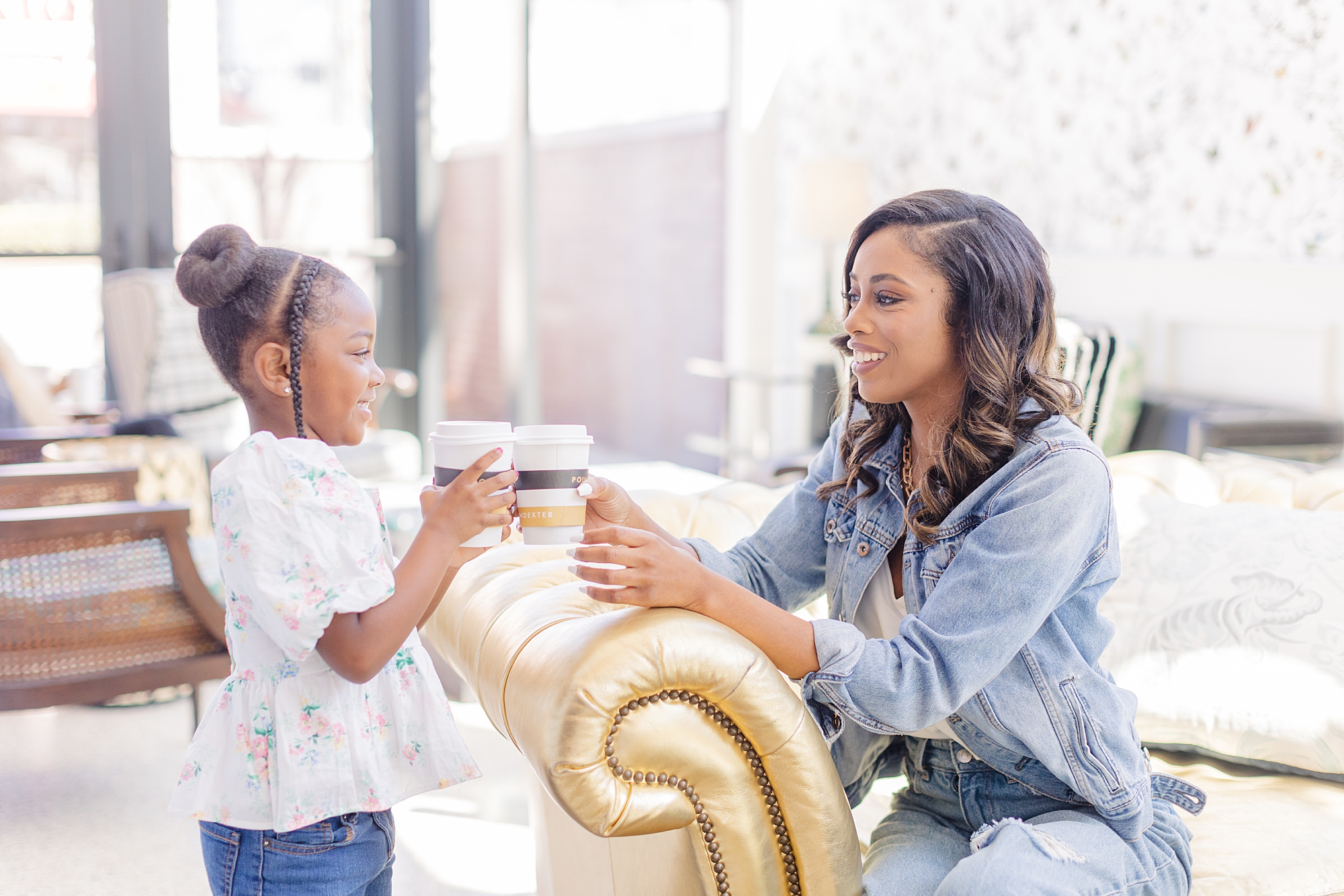 mom toasts coffee mugs with her daughter during branding photos
