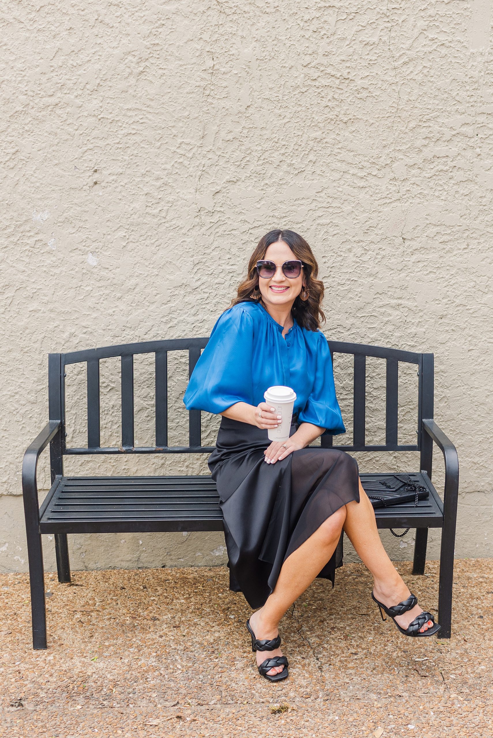 woman sits on bench in blue LILYSILK outfit