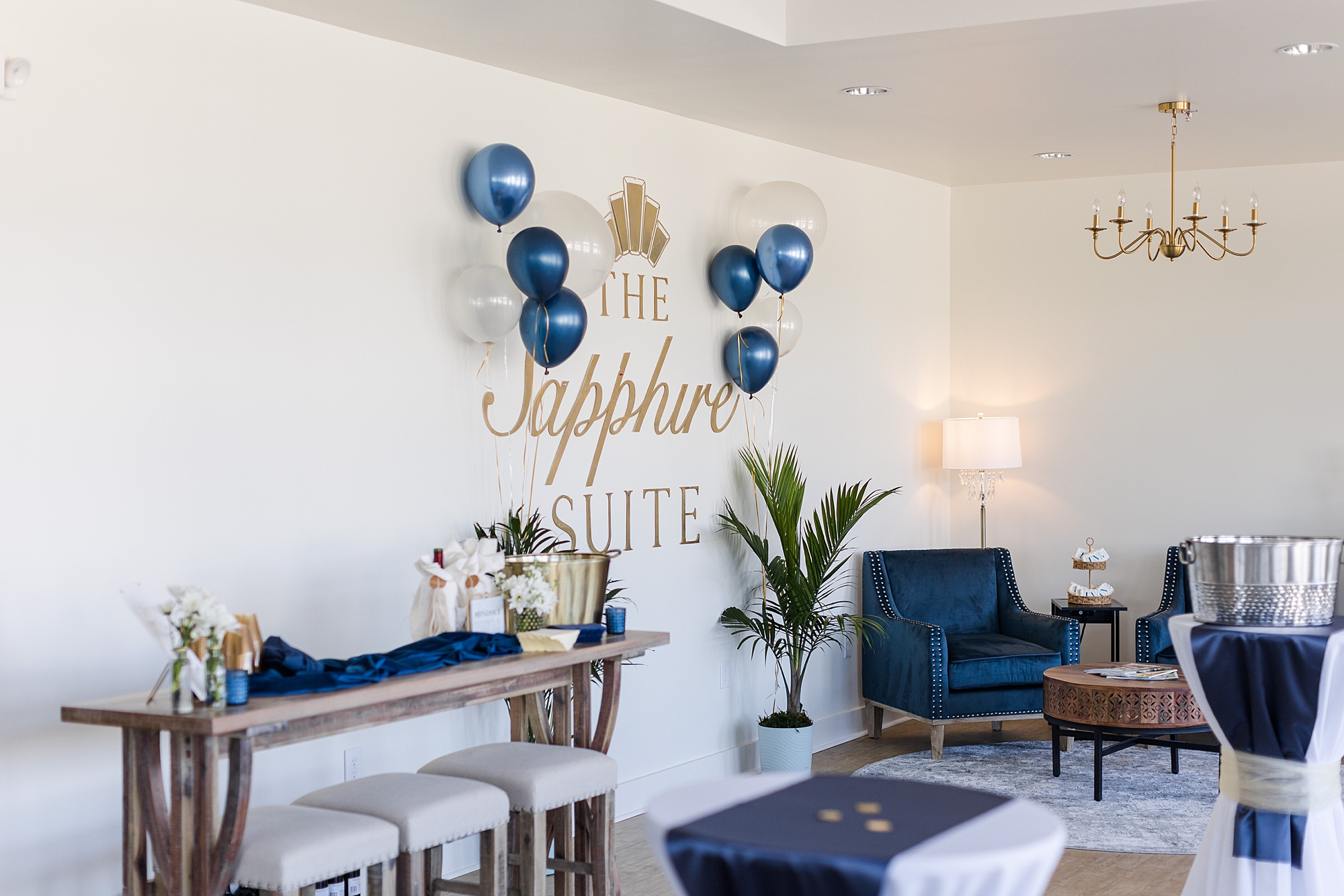 blue and gold balloons hang by The Sapphire Suite sign