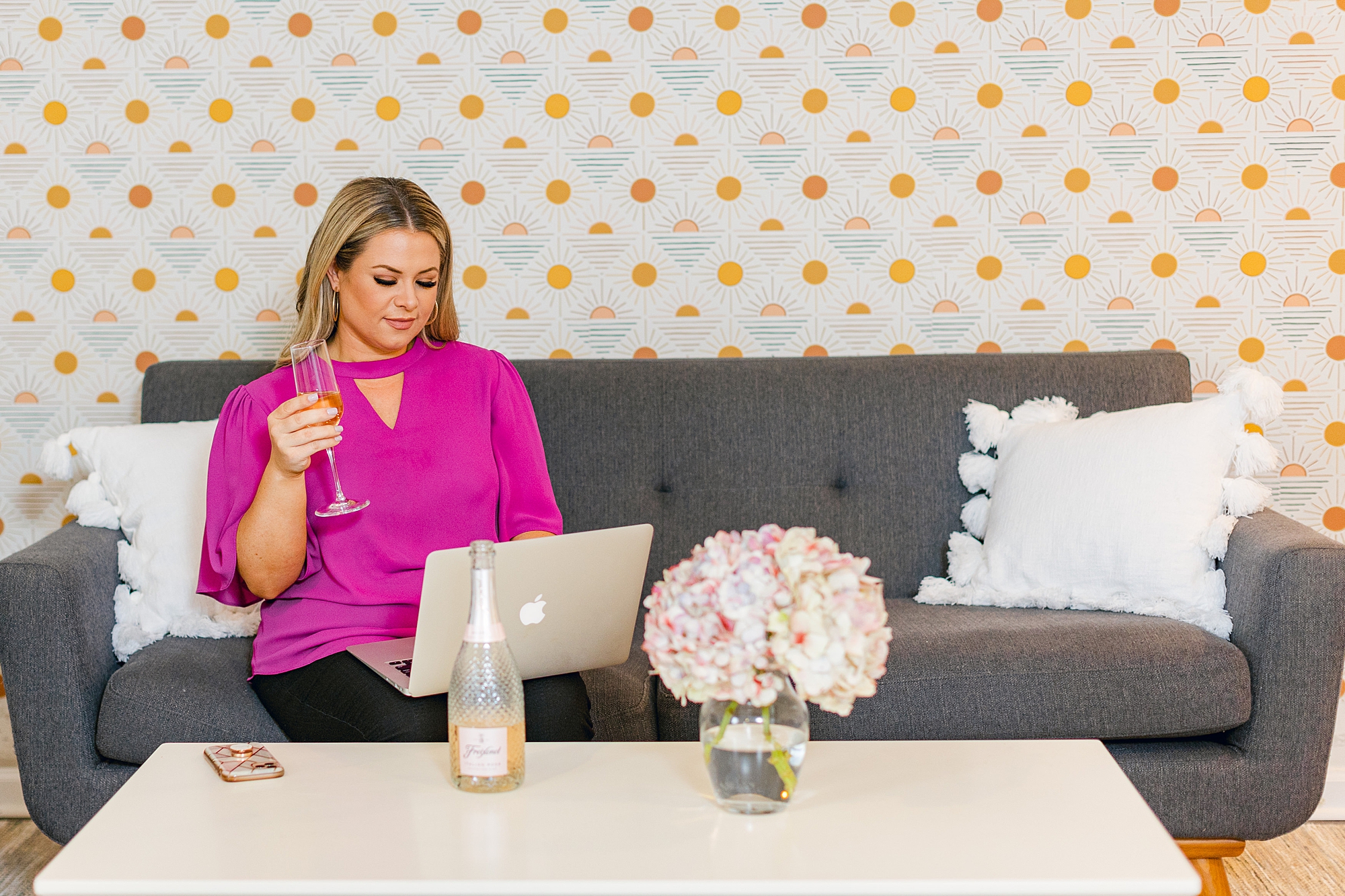 woman works on couch in office during branding photos