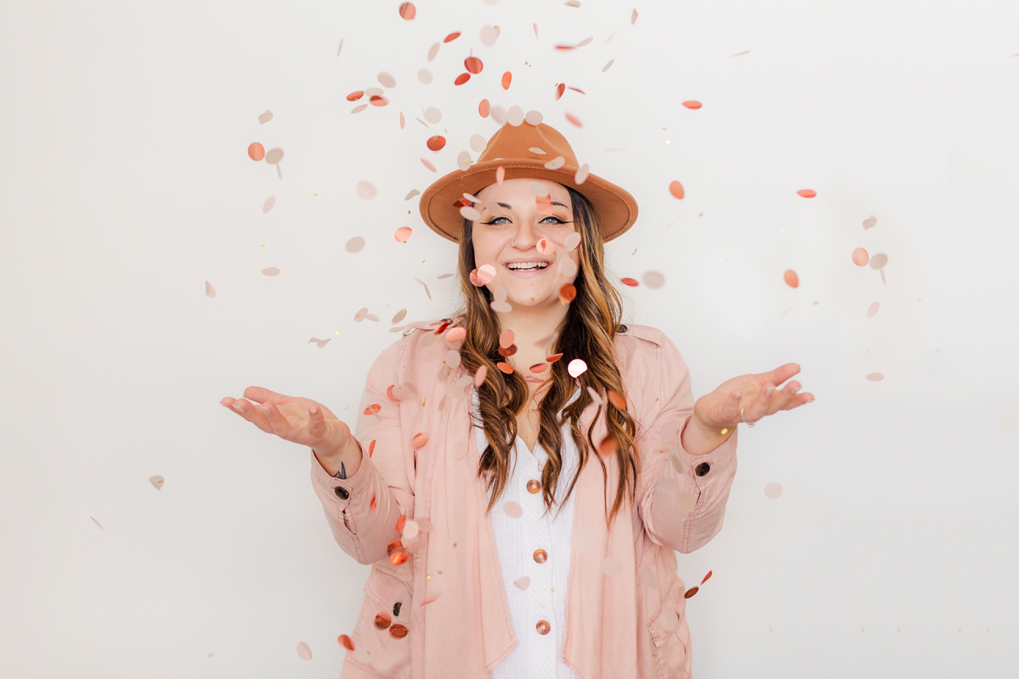business owner tosses confetti during branding photos