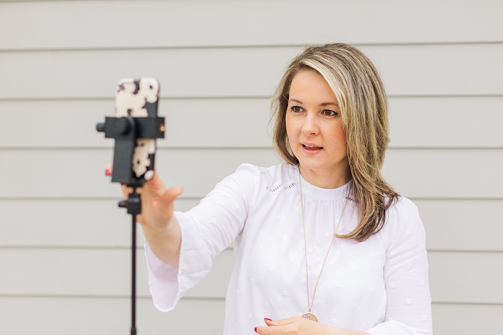 woman works with phone tripod