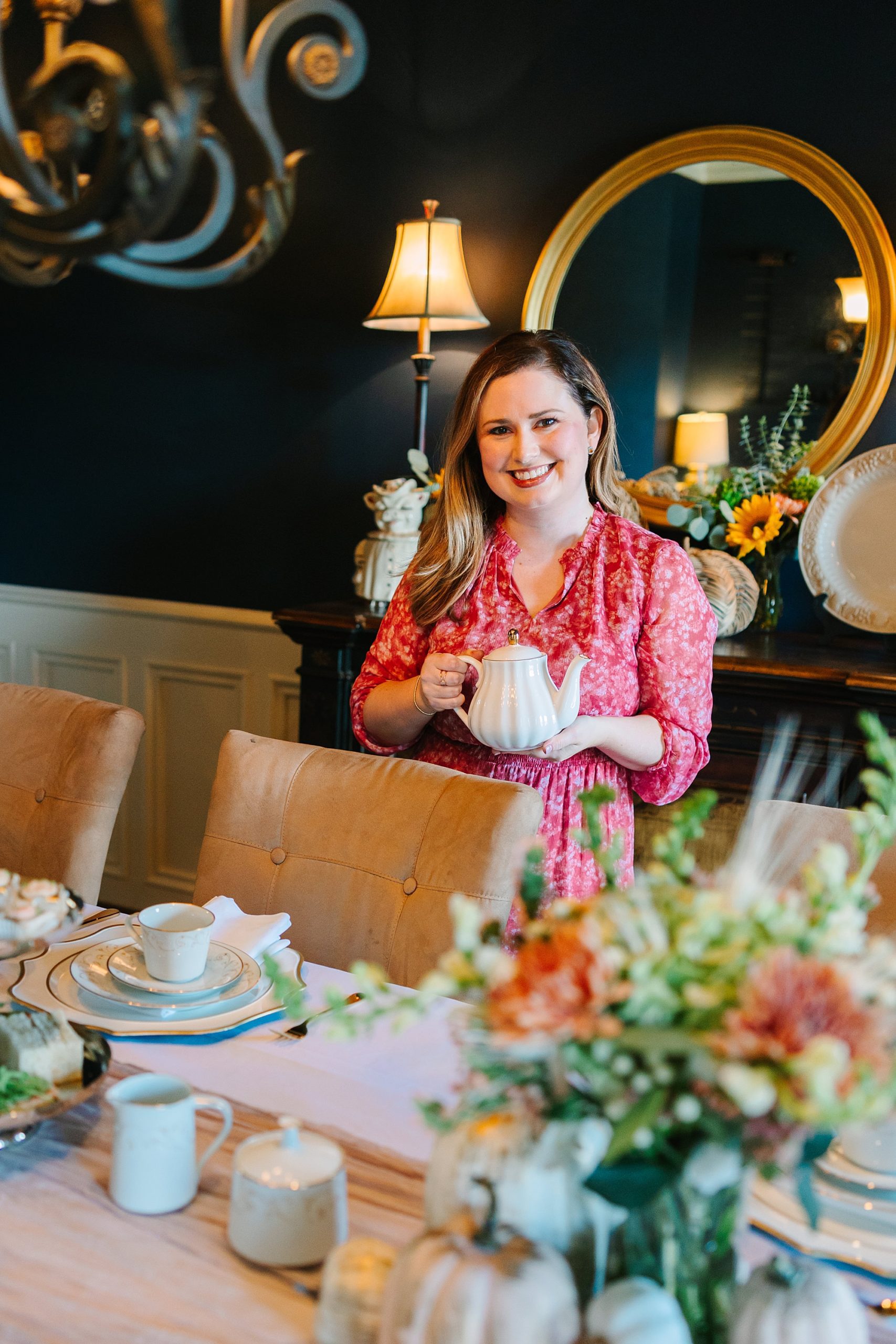 business owner holds tea pot over table during fall branding portraits