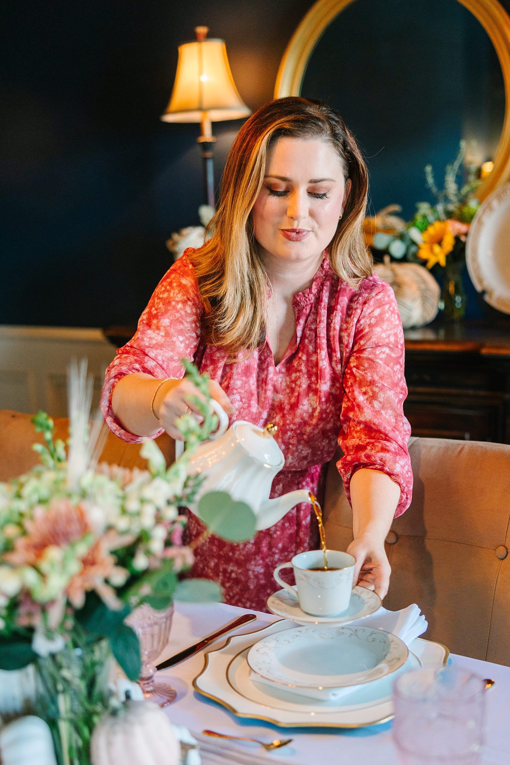 woman pours cup of tea during fall branding portraits