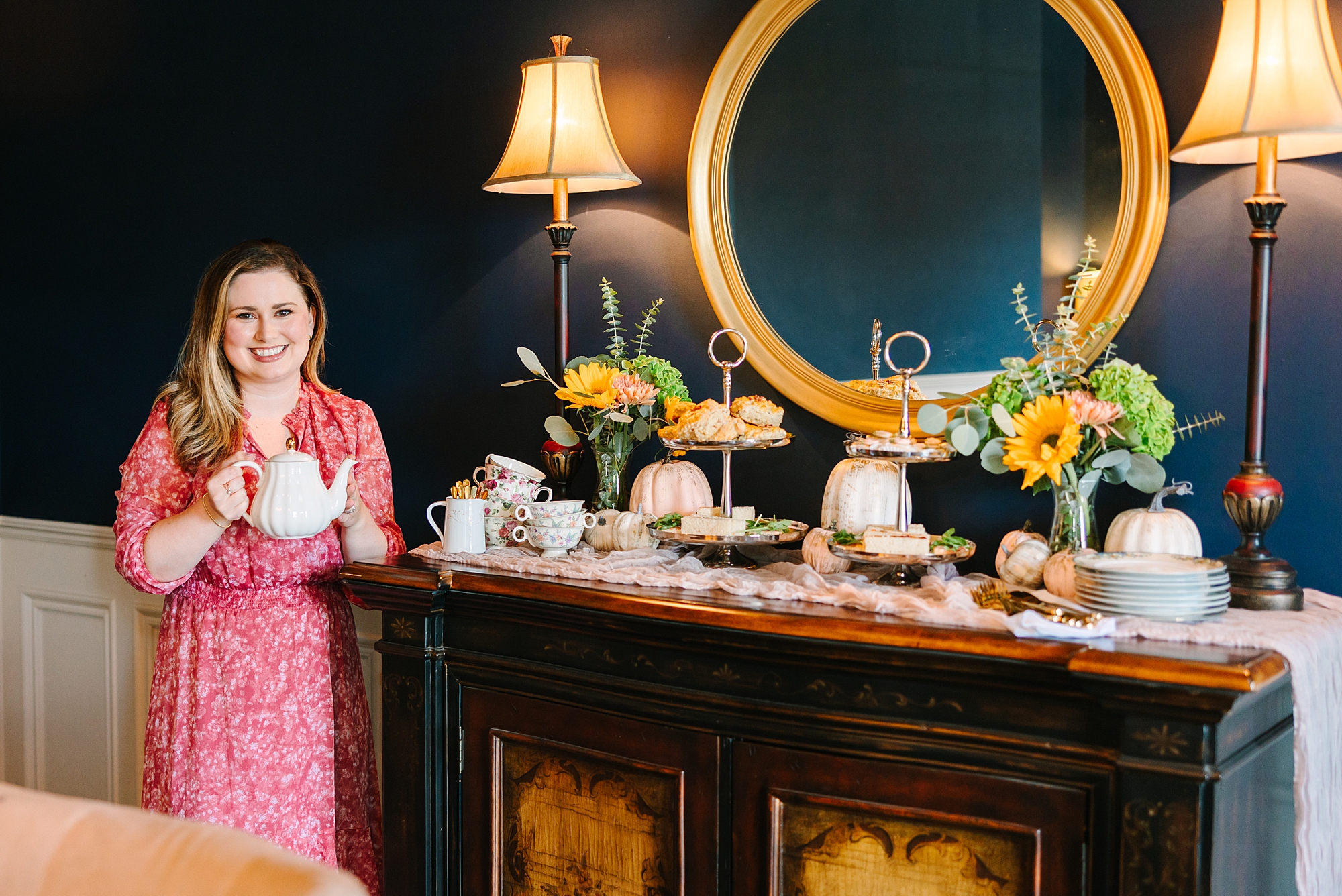 woman poses by tea set during fall branding portraits