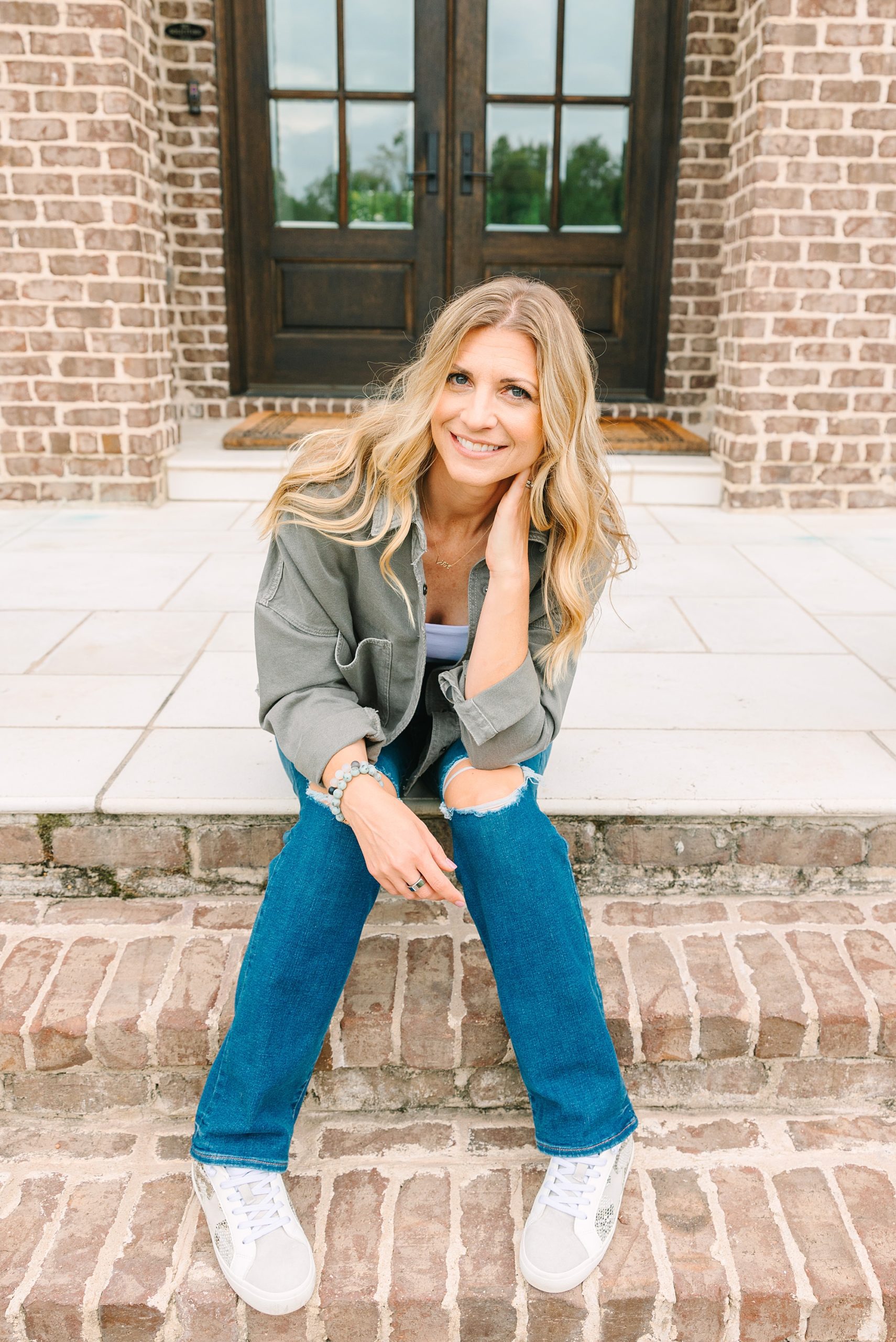 woman sits on brick steps during Nashville branding portraits