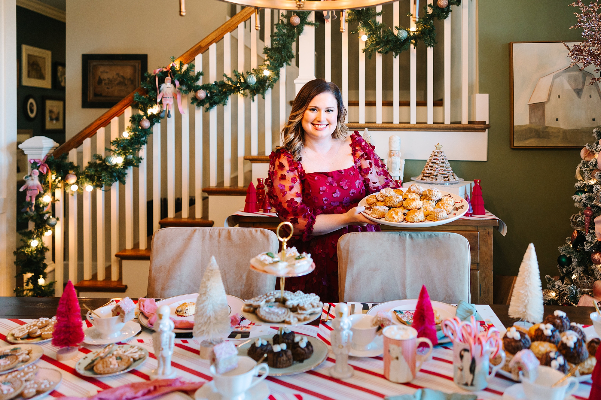 woman holds tray of cookies over table during Nutcracker inspired tea party with Pretty Lovely Tea