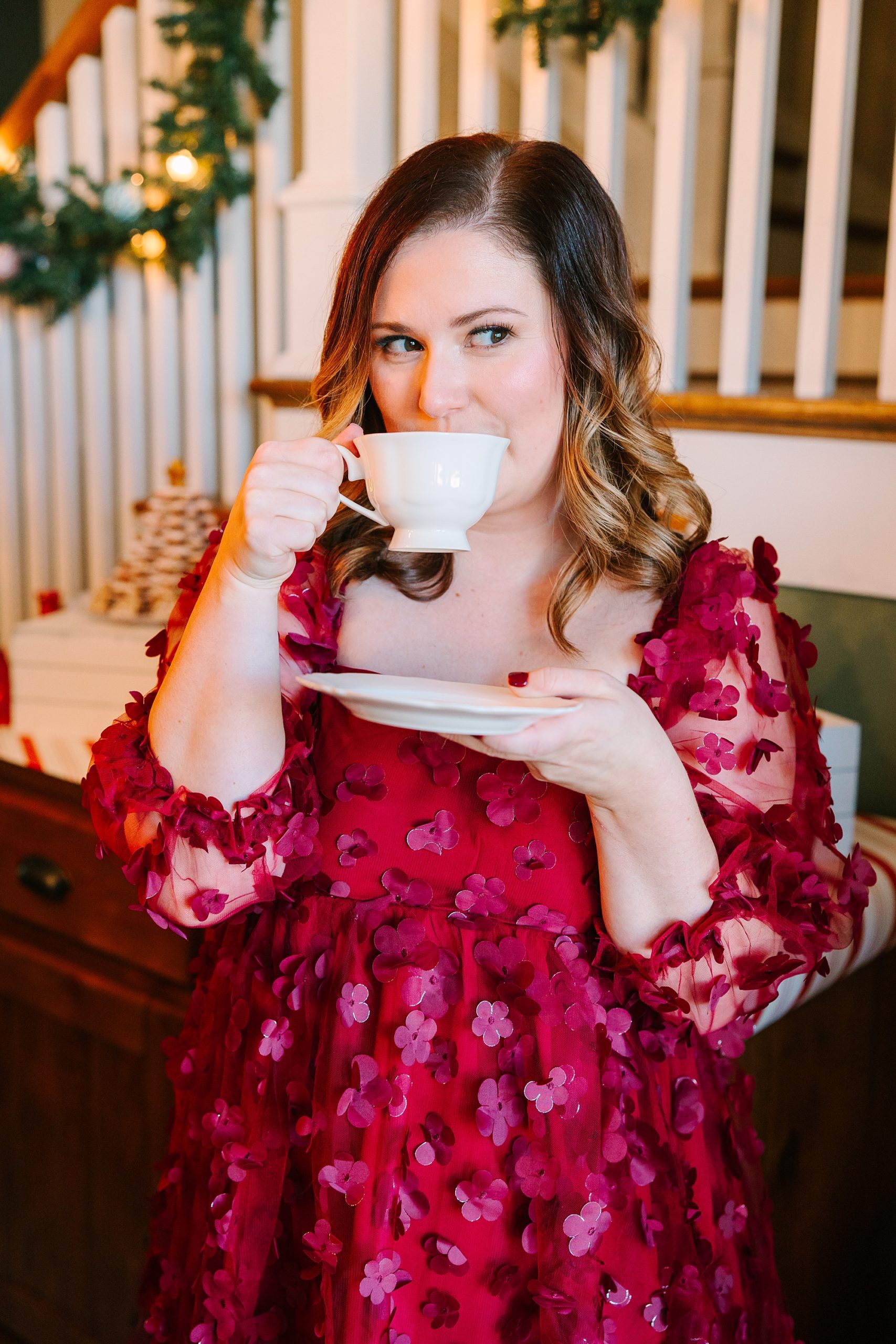 woman lifts tea cup to mouth during Nutcracker inspired tea party with Pretty Lovely Tea