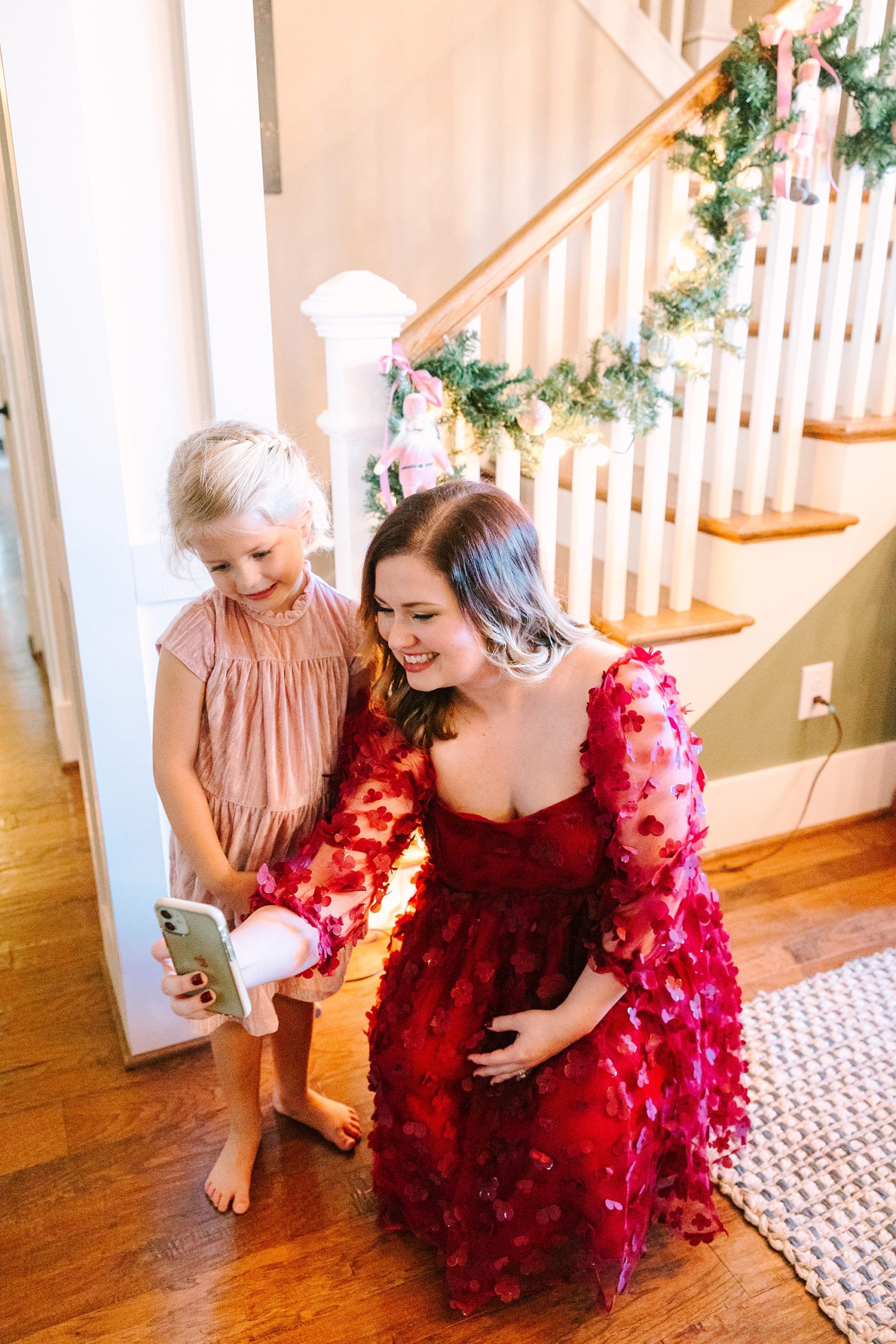 woman in red dress takes selfie with girl during Nutcracker inspired tea party with Pretty Lovely Tea