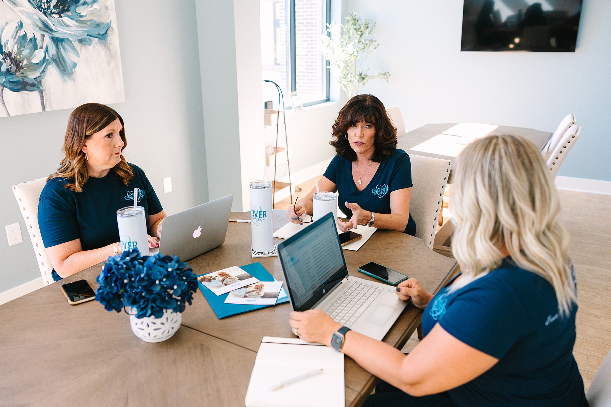 three women sit at table in The Sapphire Suite working