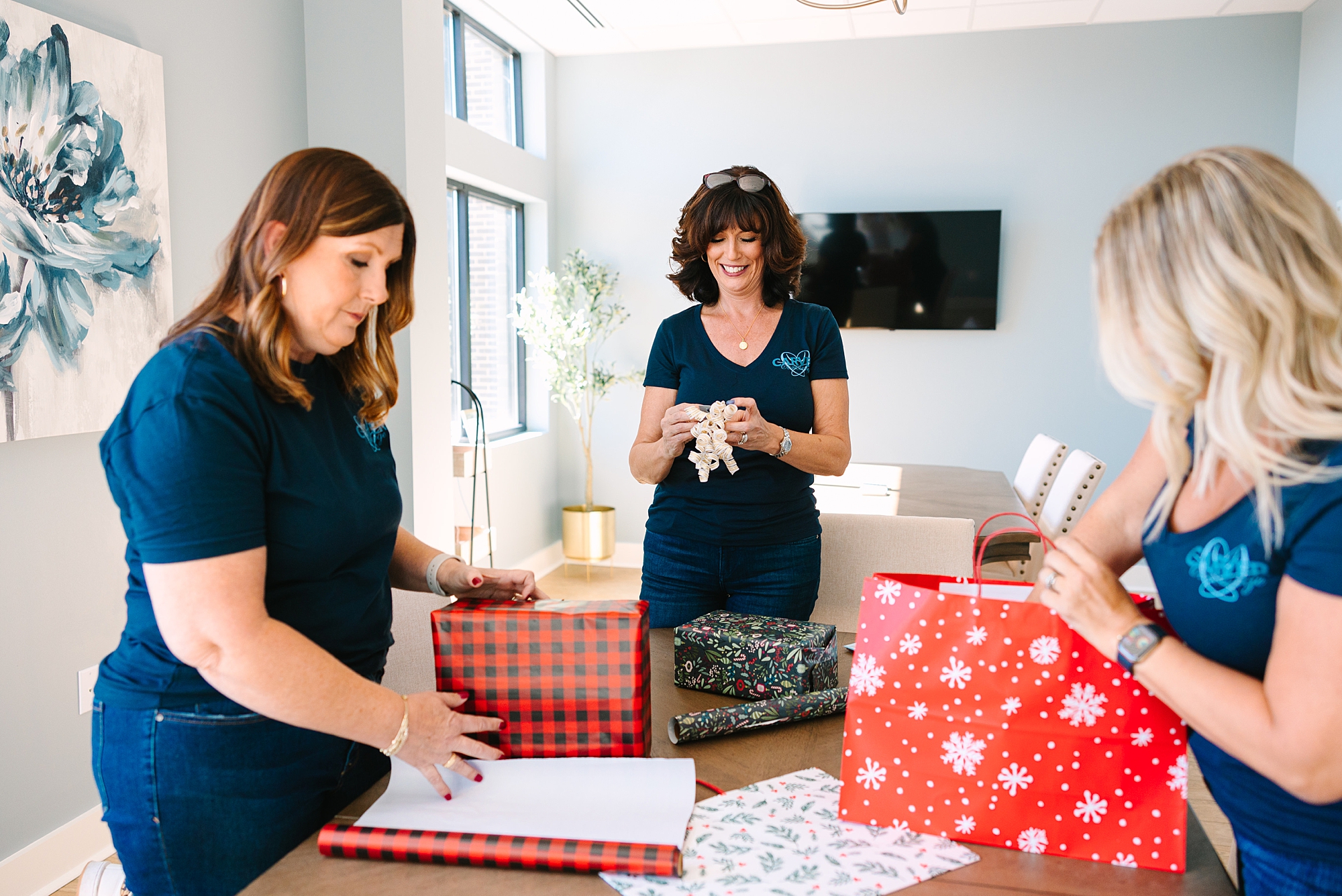 women wrap presents at The Sapphire Suite