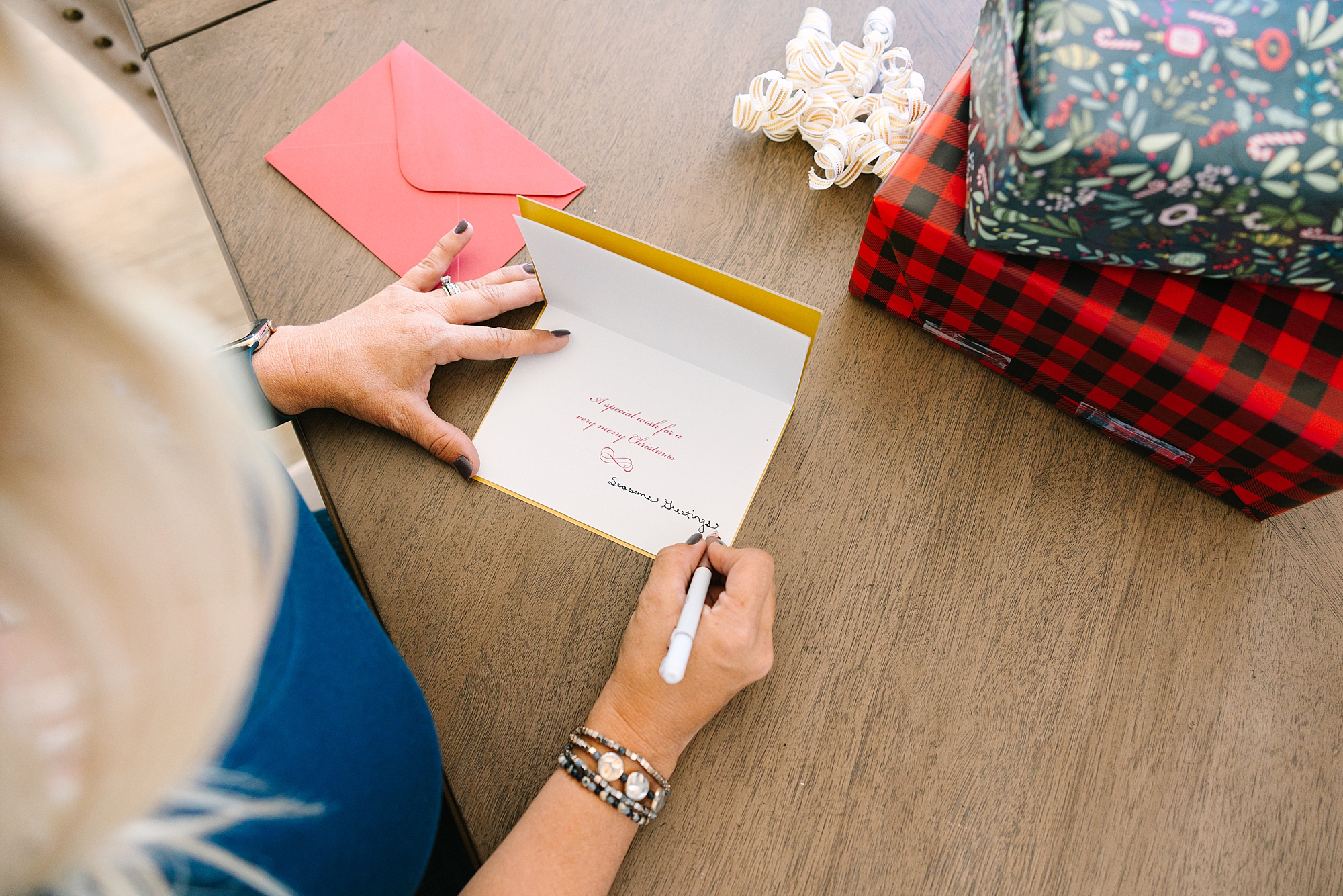 woman wraps presents and writes card at The Sapphire Suite