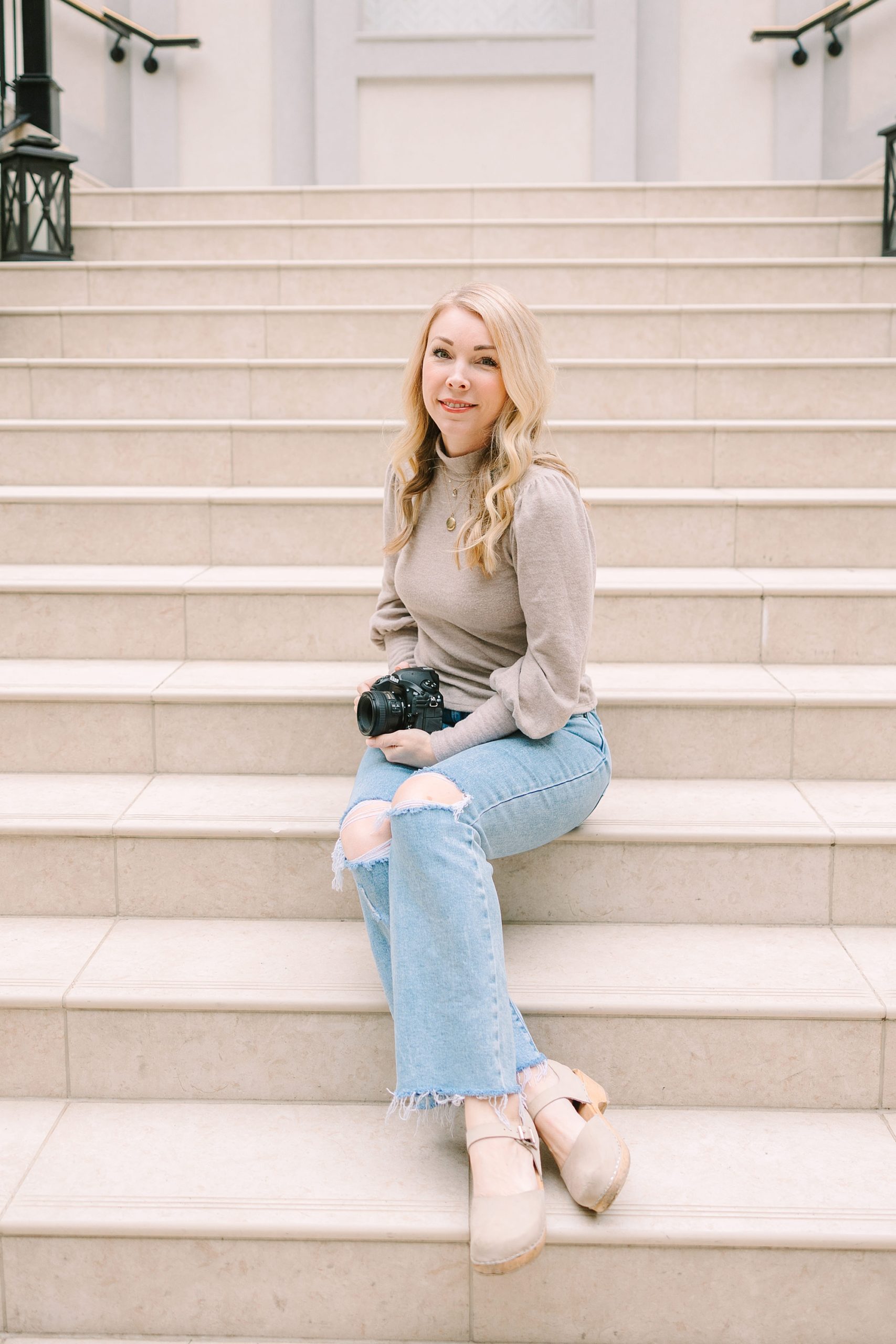 woman sits on steps in Historic Franklin during branding photos
