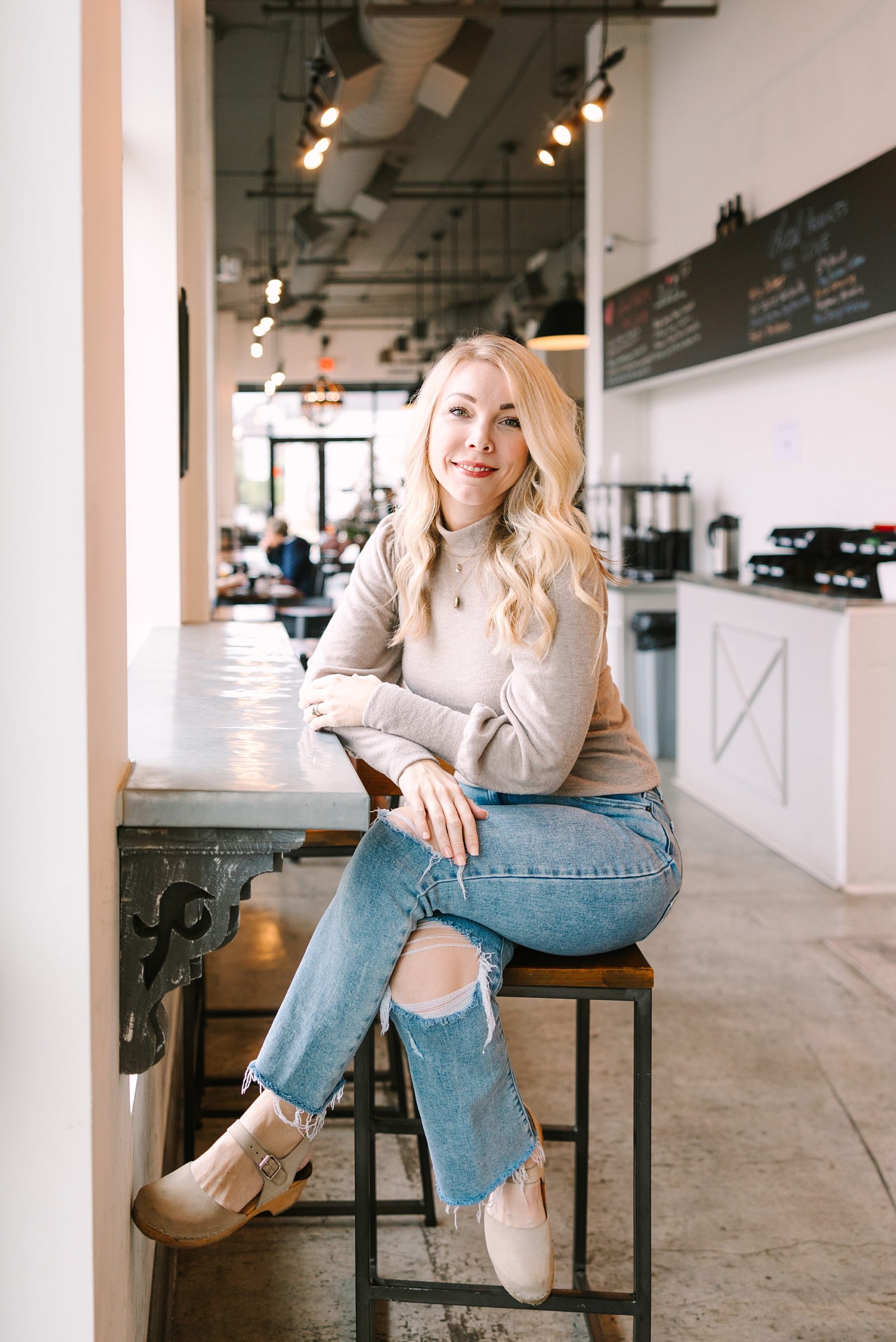 woman sits on barstool leaning on counter top at Franklin Bakehouse, in Historic Franklin