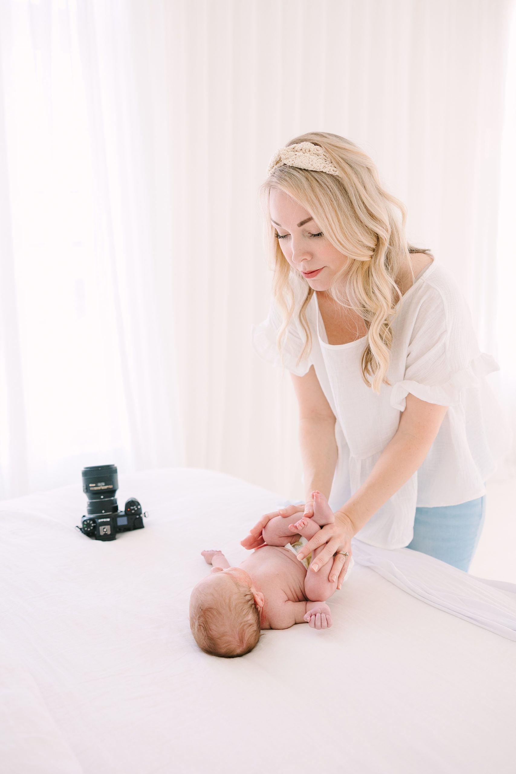 newborn photographer poses baby during newborn session