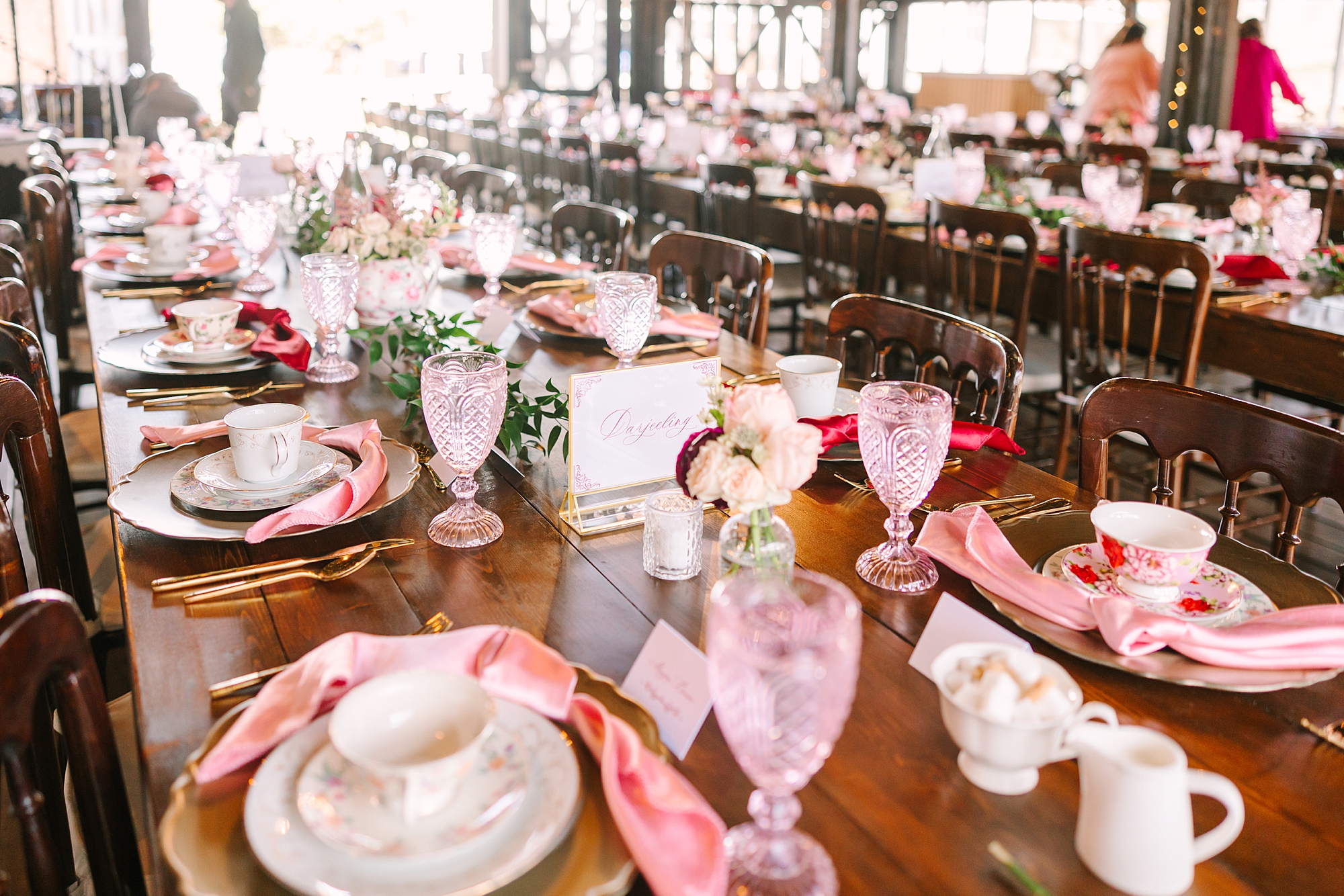 place settings with pink napkins and vintage pink glasses