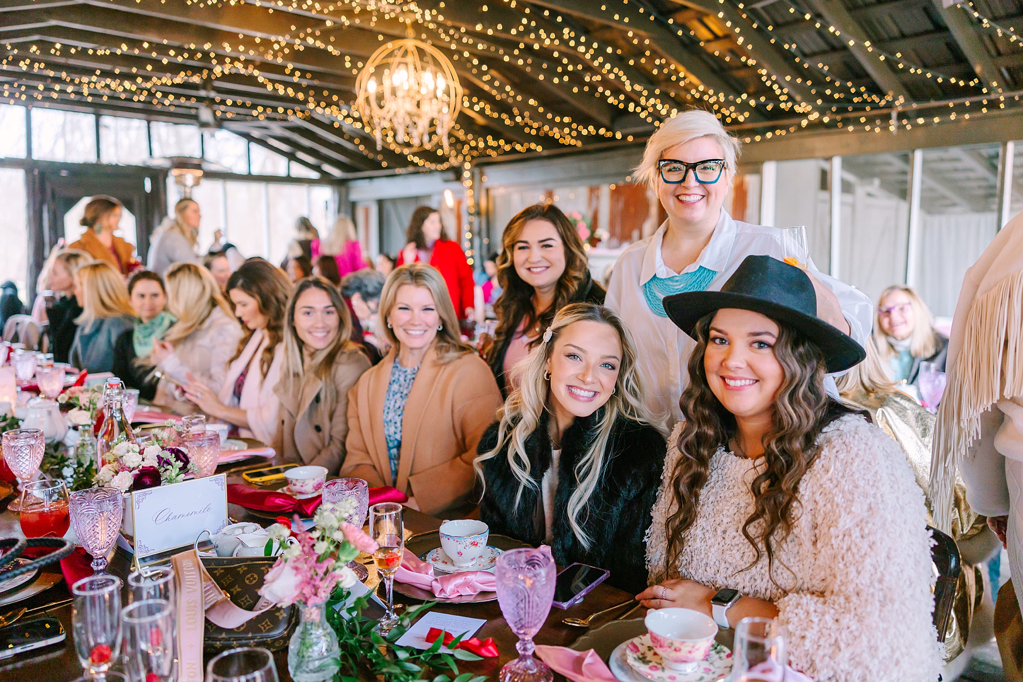 women stand together alongside table at Magnolia Acres