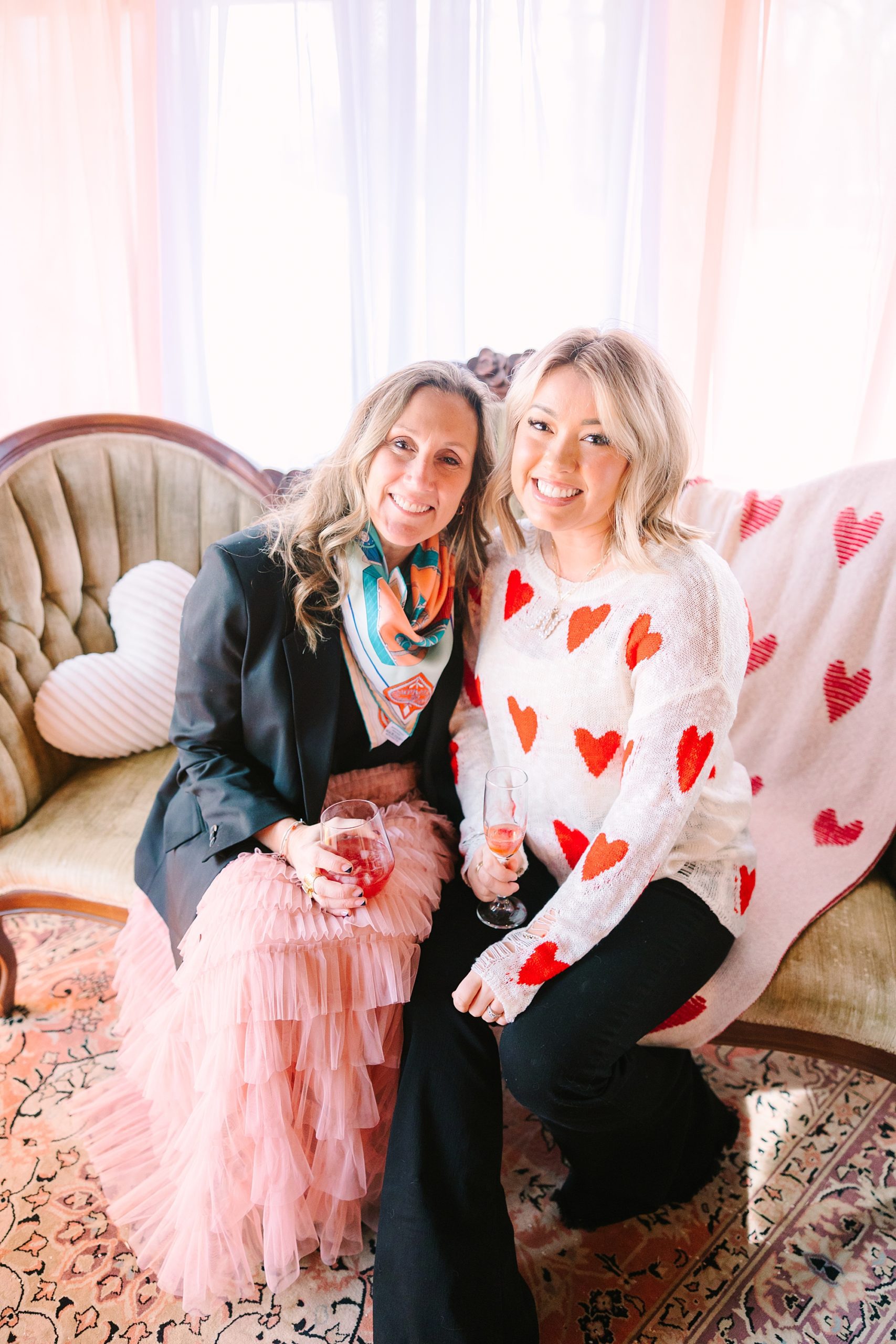women sit on vintage couch during Galentine's Day Tea Party