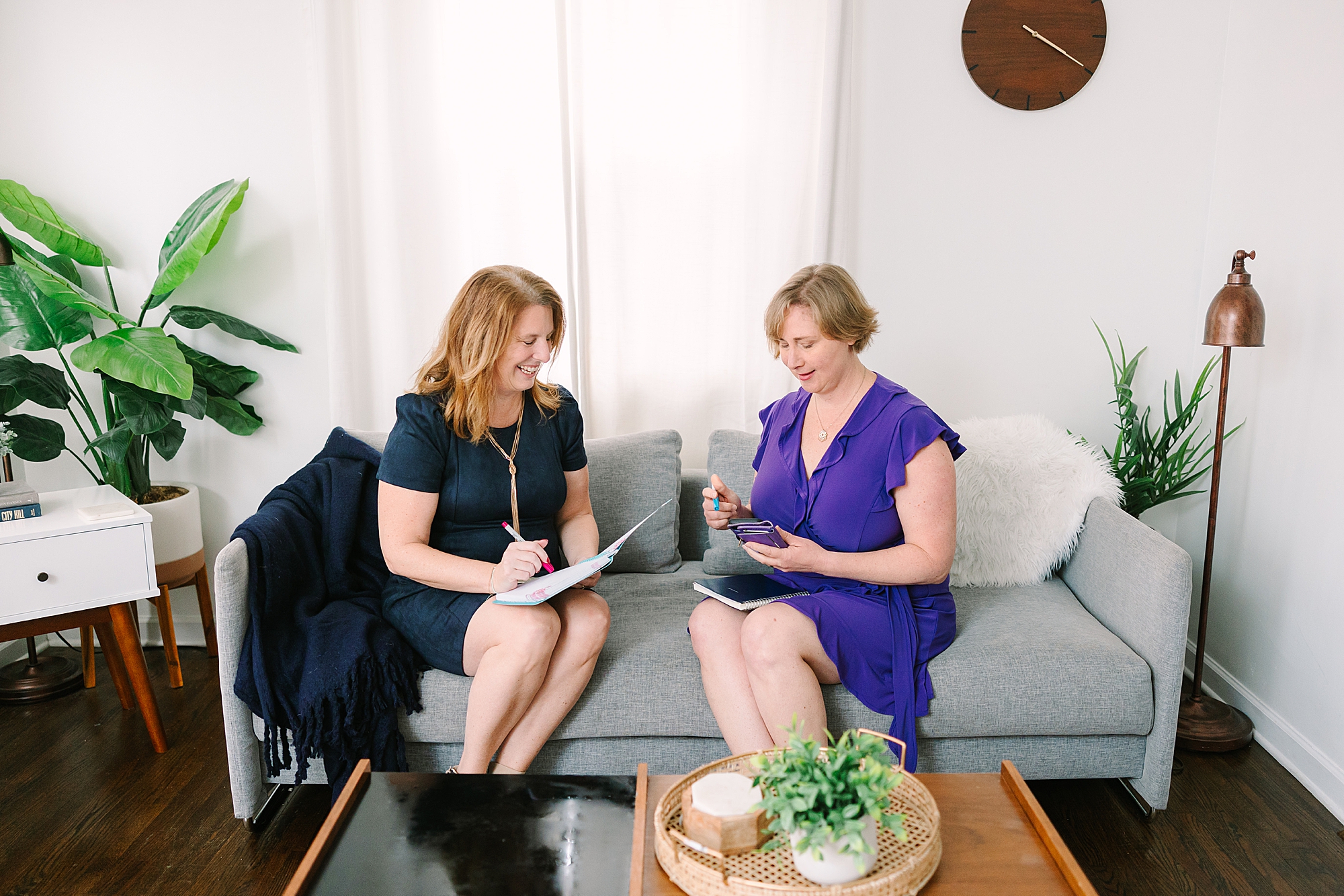 two woman sit on couch working during Nashville branding session