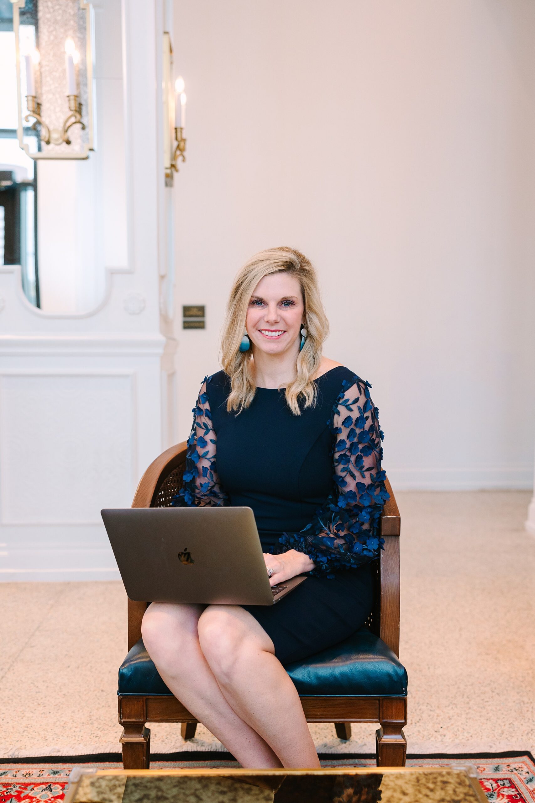 woman in blue dress works on laptop during Nashville branding session