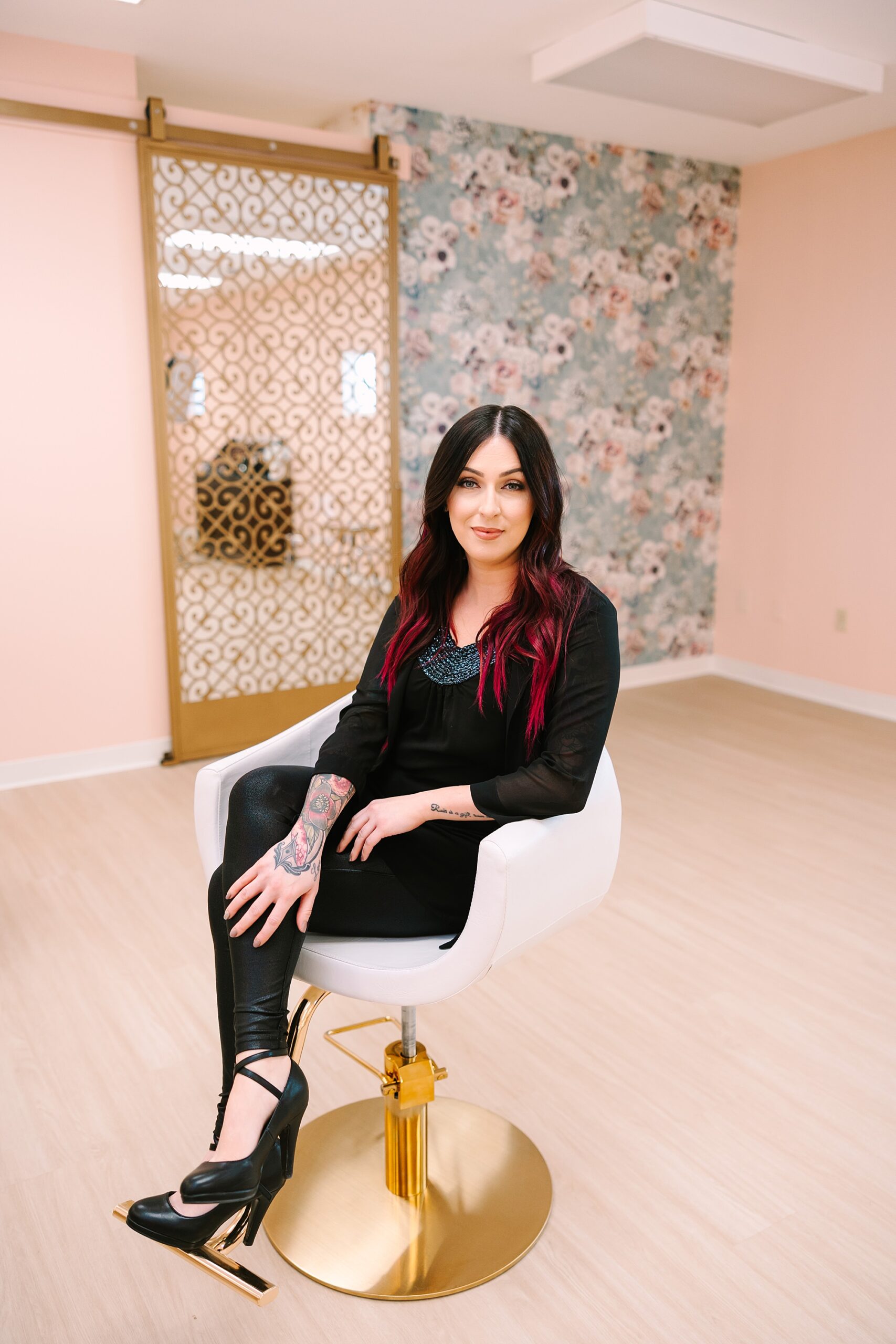 dark haired stylist sits in white chair during MHD Beauty Parlor branding session