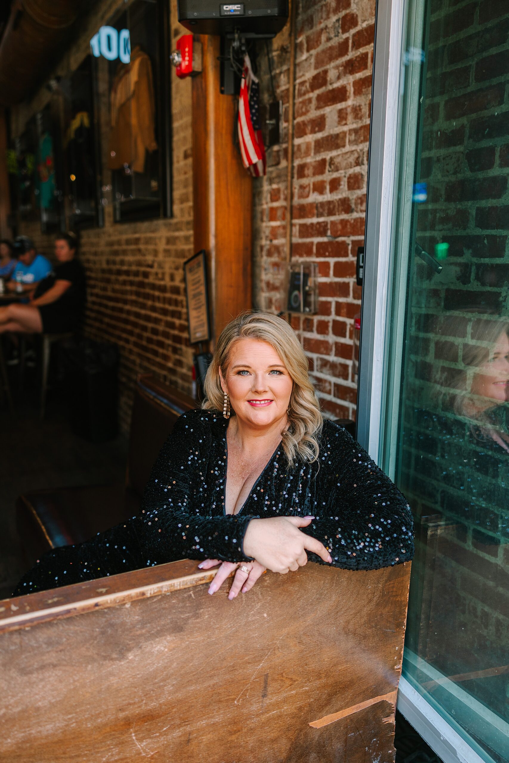 woman sits in booth in Nashville honky tonk bar