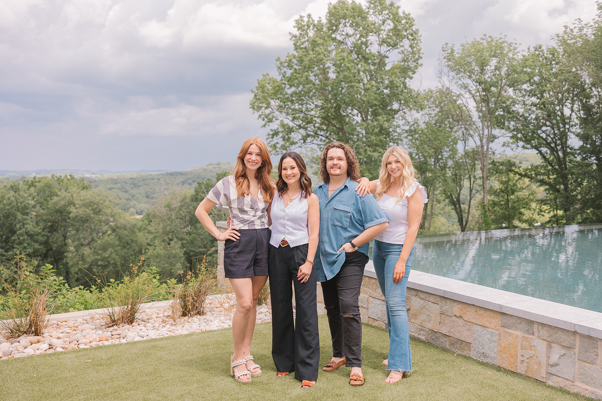 team of wardrobe stylists stand by pool during Nolensville TN branding session