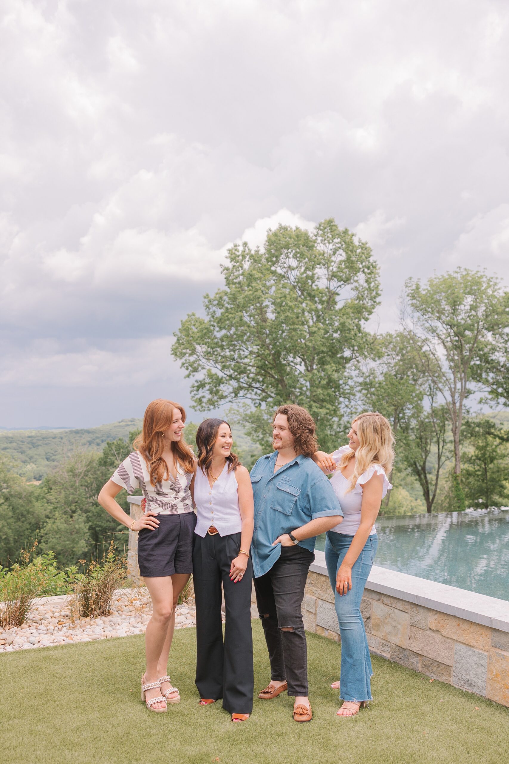 team of wardrobe stylists pose together near pool during Nolensville TN branding session