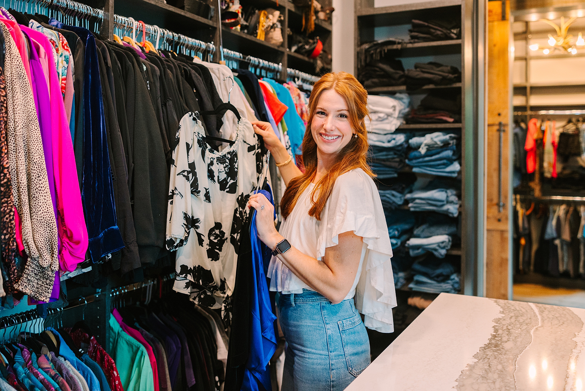 stylist from Be Styled Co. goes through clothes in closet